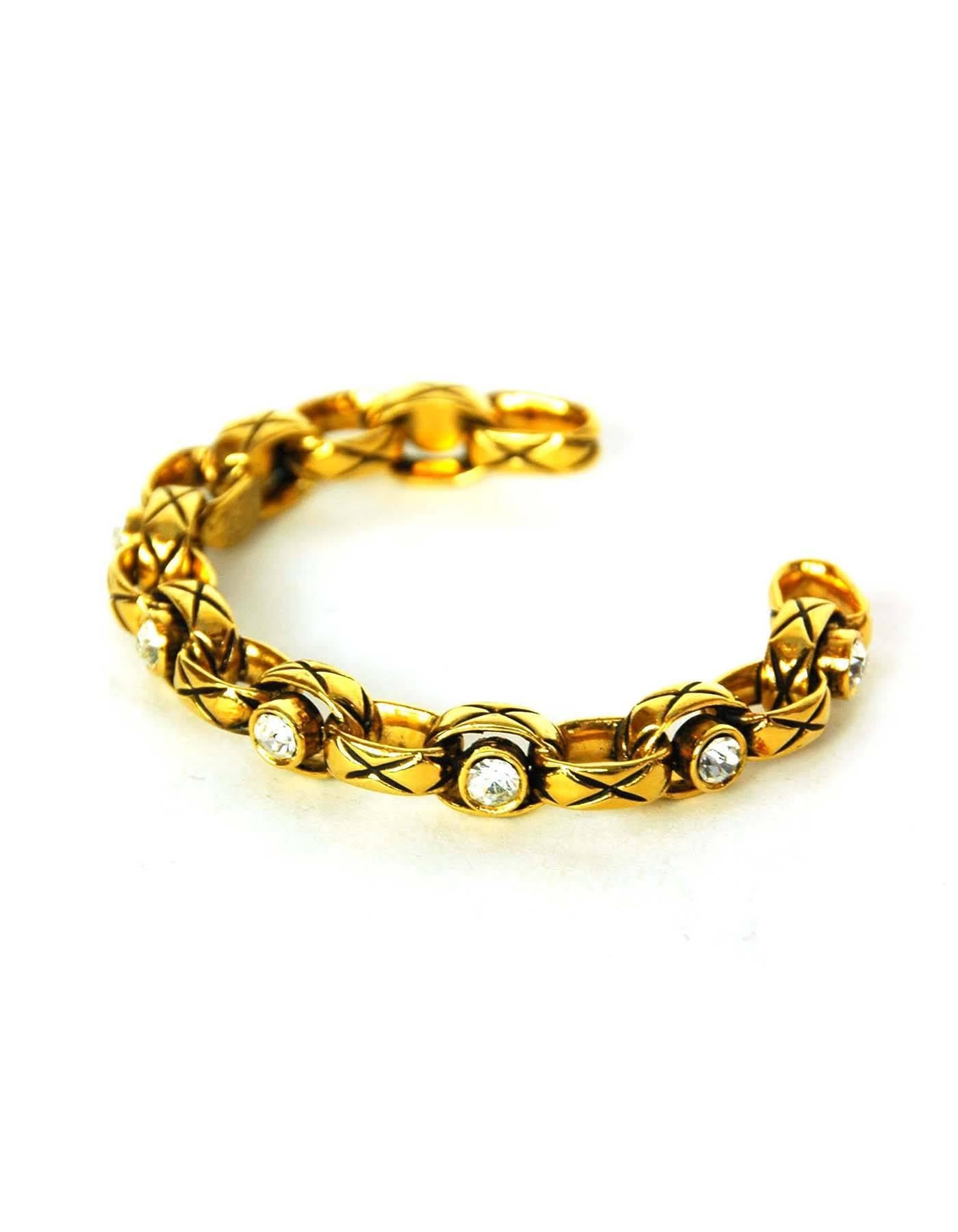 Chanel Vintage '86 Crystal & Gold Cuff Bracelet
Features quilting at goldtone chain links

Made In: France
Year of Production: 1986
Color: Goldtone and clear
Materials: Metal and crystal
Closure: None
Stamp:  2 CC 3
Overall Condition: Excellent