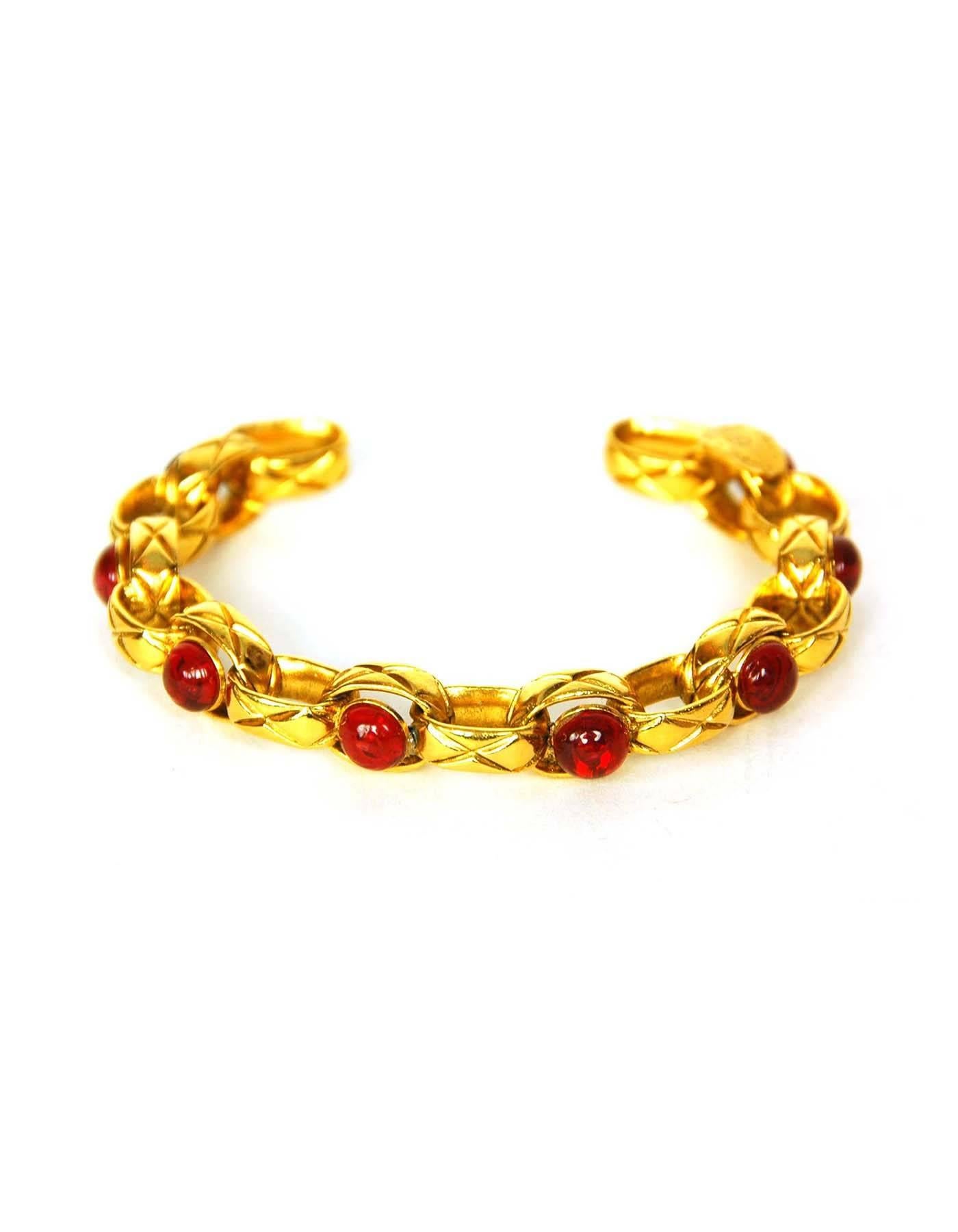 Chanel Vintage '86 Red Gripoix & Gold Cuff Bracelet
Features quilting at goldtone chain links

Made In: France
Year of Production: 1986
Color: Goldtone and red
Materials: Metal and gripoix (poured glass)
Closure: None
Stamp:  2 CC 3
Overall