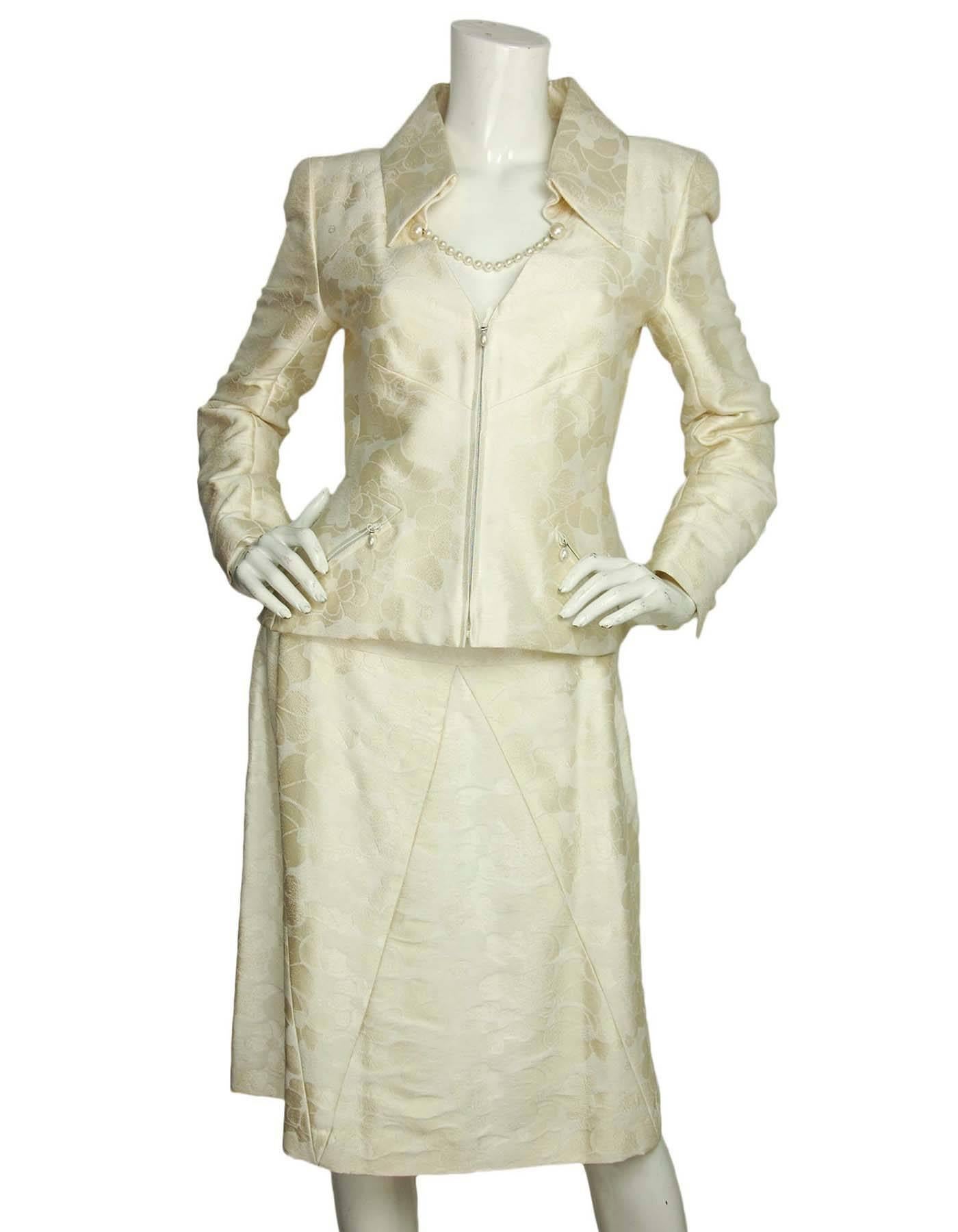 Chanel Cream Camelia Print Skirt Suit
Features faux pearls at pockets and strands that attach under collar with hook and eye closure

Made in: France
Year of Production: 2001
Color: Cream
Materials: 48% cotton, 28% rayon, 24% silk
Lining: 100%