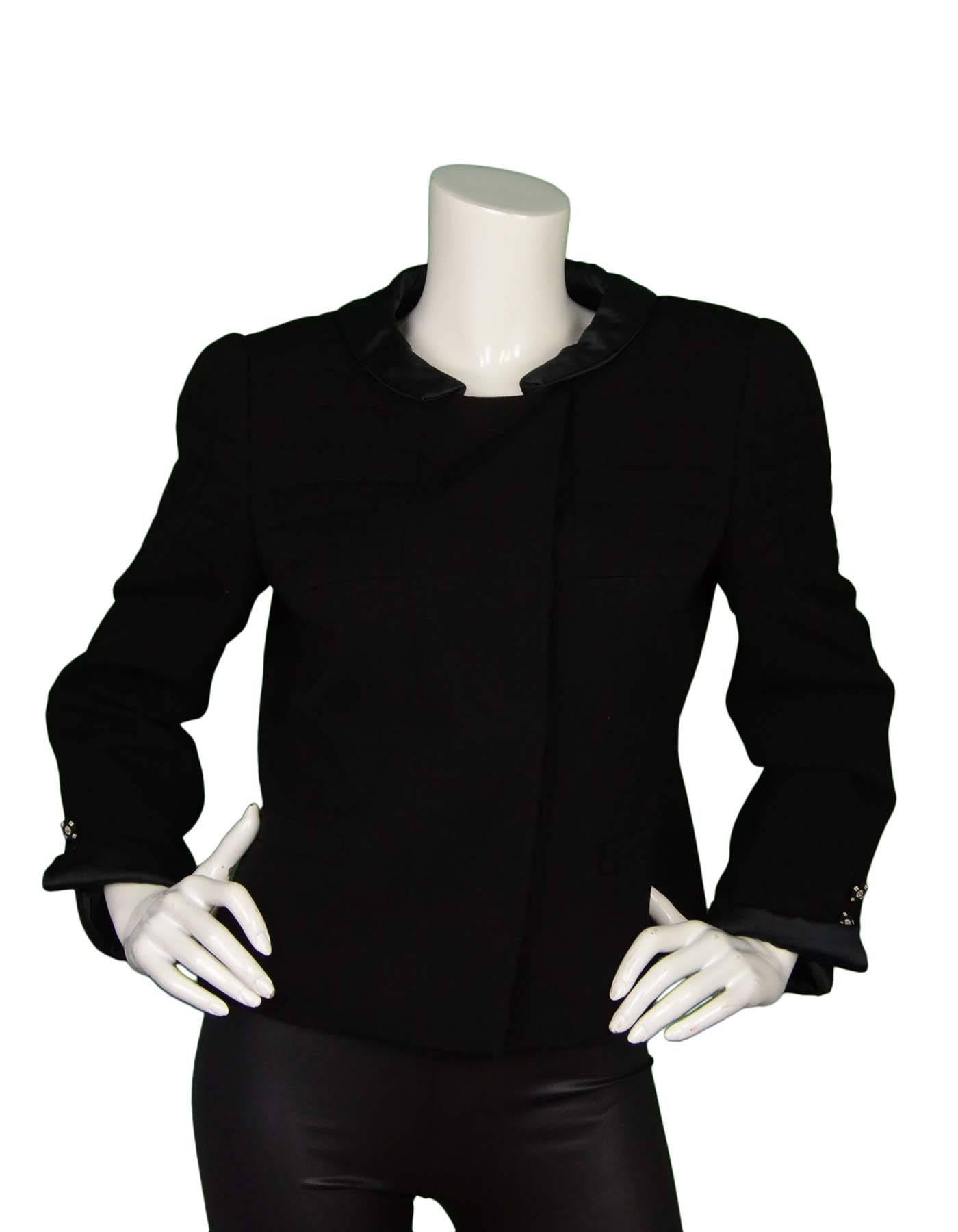 Chanel Black Wool Jacket Sz 44
Features light shoulder padding with quilted detail, and sateen trim at collar and sleeves with rhinestone buttons

Made In: France
Year of Production: 2006 Autumn
Color: Black
Composition: 100% Wool
Lining:
