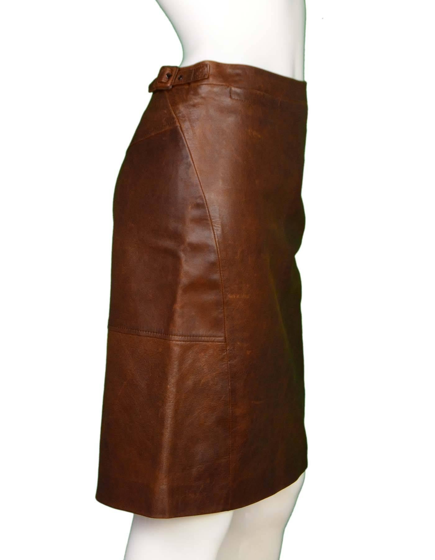 MaxMara Brown Leather Skirt Sz 4
Features buckle details at sides

Made In: Italy
Color: Brown
Composition: 100% Leather
Lining: Brown textile
Closure/Opening: Hidden back zip closure
Overall Condition: Very goof pre-owned condition - gentle