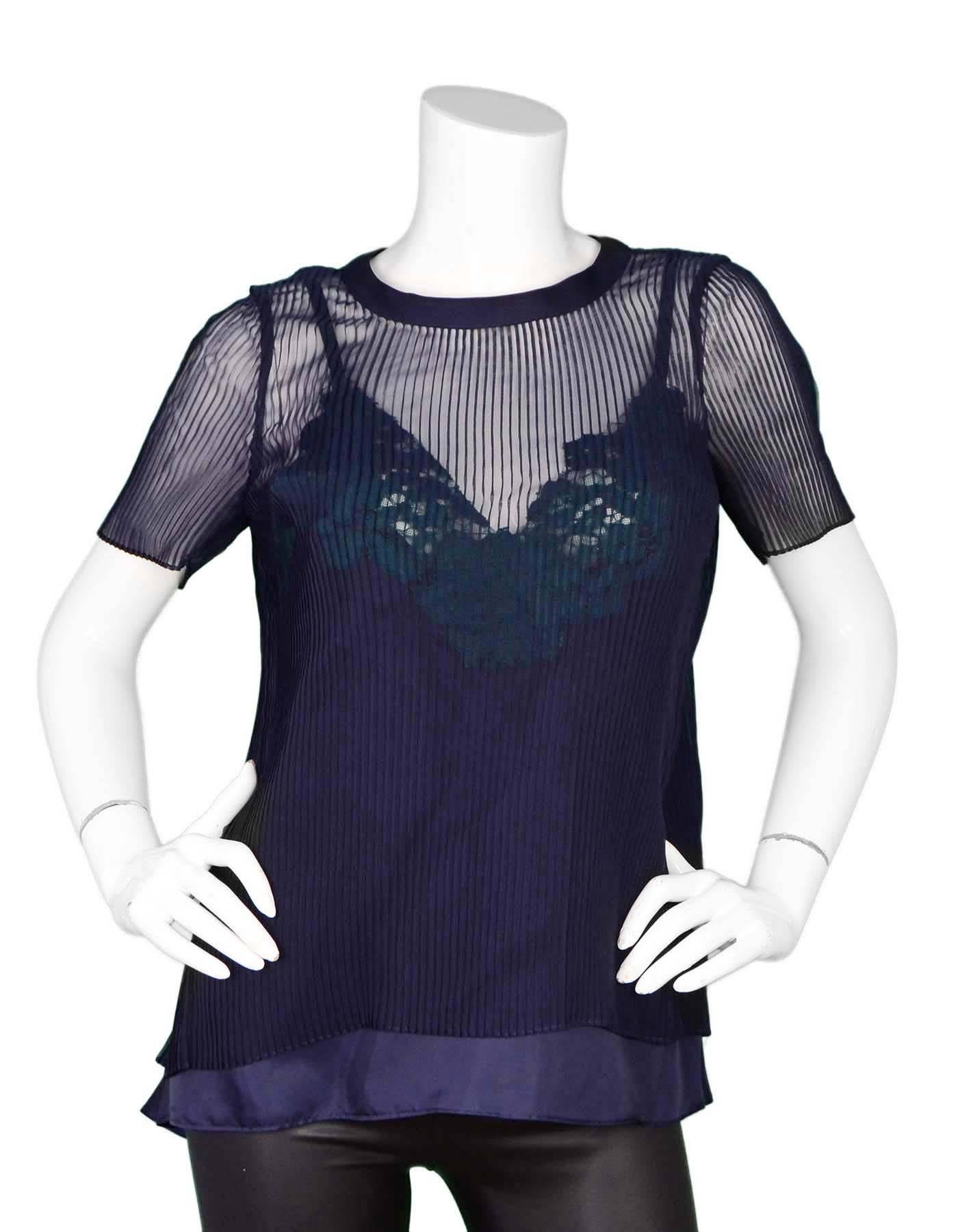 Sacai Navy Pleated Sheer Top Sz S
Features green lace detail underneath pleats and at at back

Made In: Japan
Color: Navy
Composition: 100% Polyester
Lining: None
Closure/Opening: Pull over with single button closure at back of neck
Overall