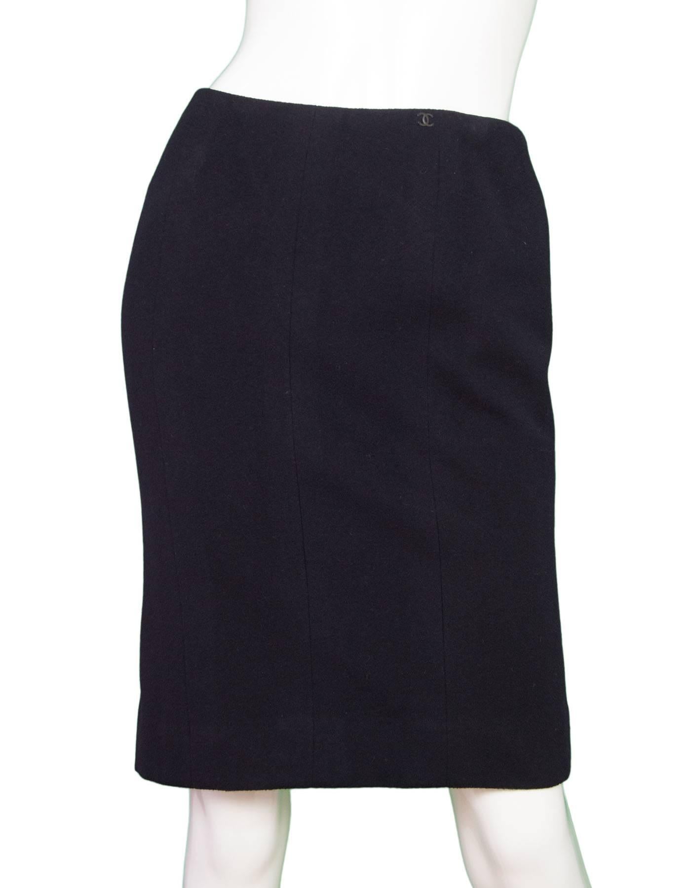 Chanel Black Cashmere Pencil Skirt 

Features small CC button stitched at left hip
Made In: France
Year of Production: 2002
Color: Black
Composition: 100% cashmere
Lining: Black, 95% silk, 5% spandex
Closure/Opening: Back center zipper