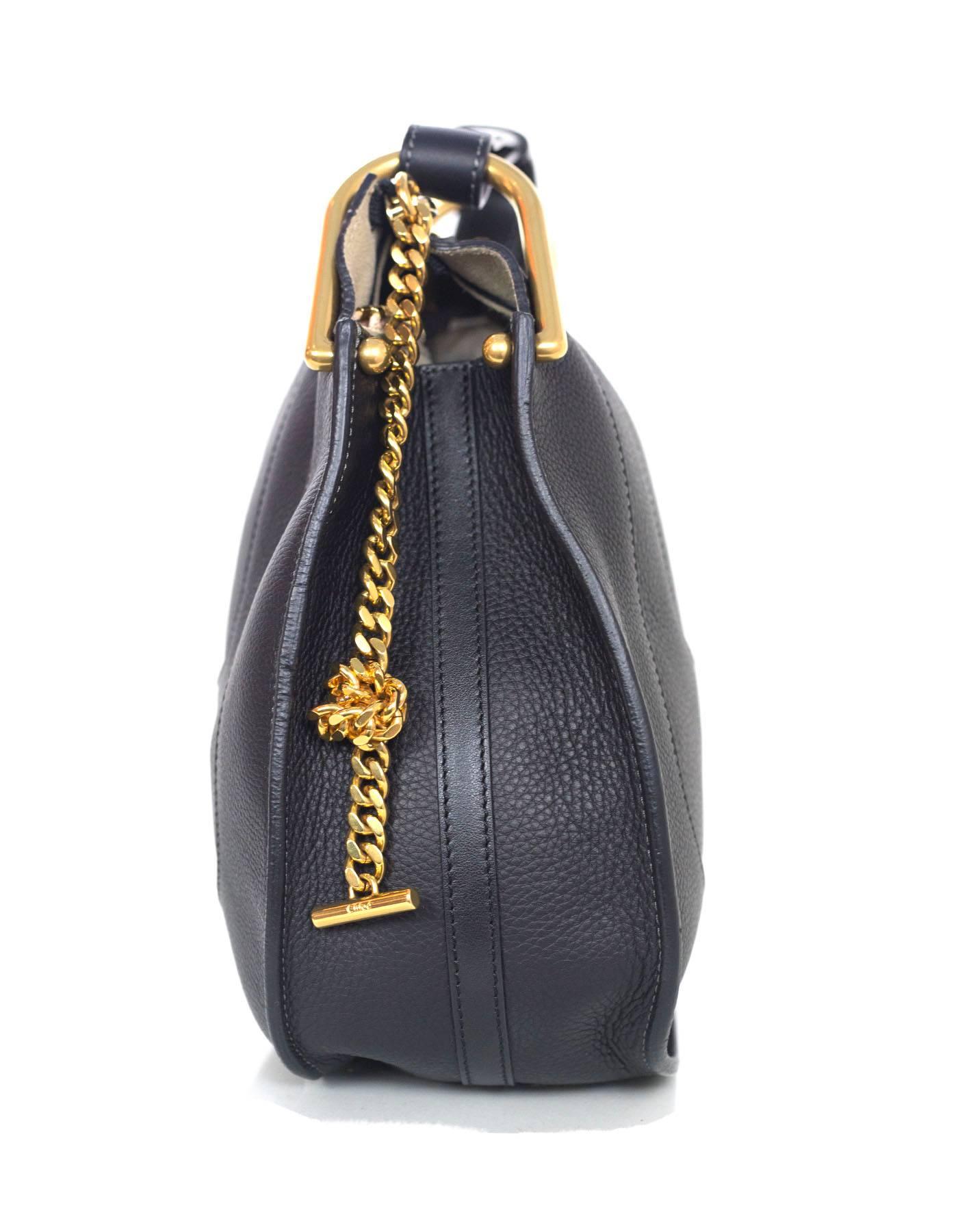 100% Authentic Chloe Black Leather "Hayley" Shoulder Bag. Features classic saddle shape with decorative seaming, textured leather, zip top closure with chain pull, gold hardware and studs. Comes with dust bag, care card, authenticity card,