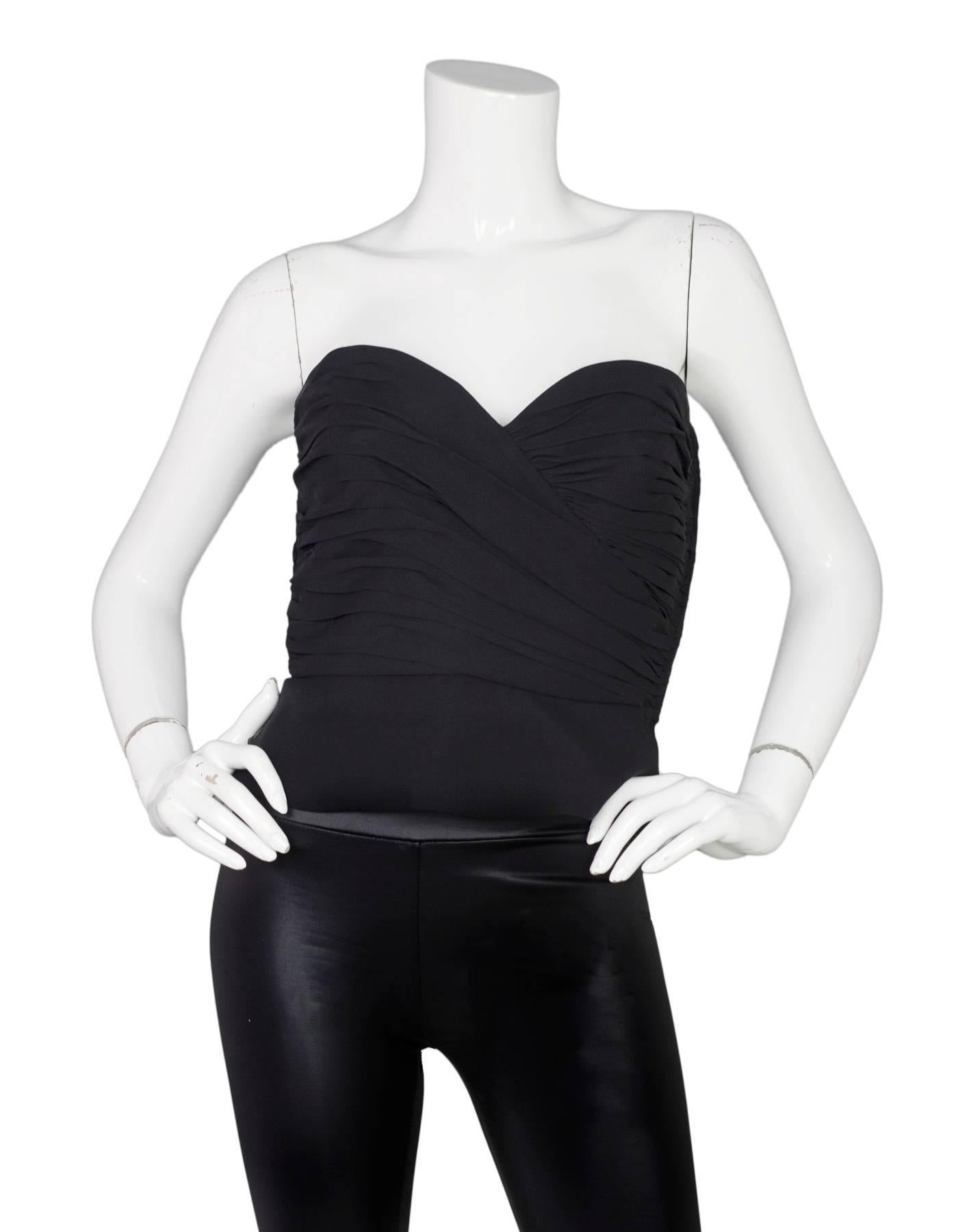 Giorgio Armani Black Silk Bustier
Features light weight silk peplum at hemline

Made In: Italy
Color: Black
Composition: Believed to be 100% silk
Lining: Black, silk blend
Closure/Opening: Side zip up with hook and eye closure
Exterior Pockets: