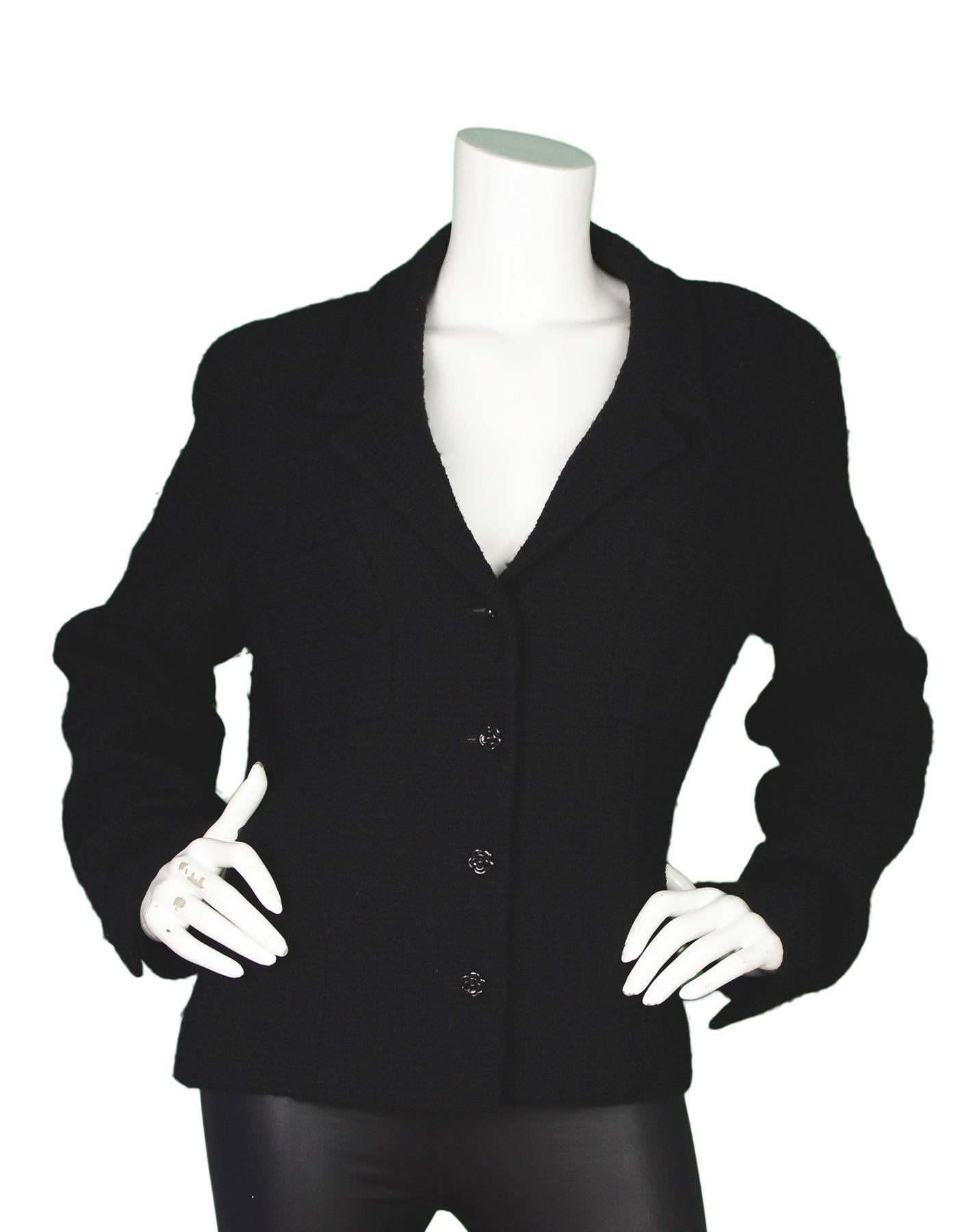 Chanel Black Boucle Jacket
Features camelia button detailing

Made In: France
Year of Production: 2002
Color: Black 
Composition: 85% wool, 15% angora
Lining: Black, 95% silk, 5% spandex
Closure/Opening: Button down front
Exterior Pockets: Two