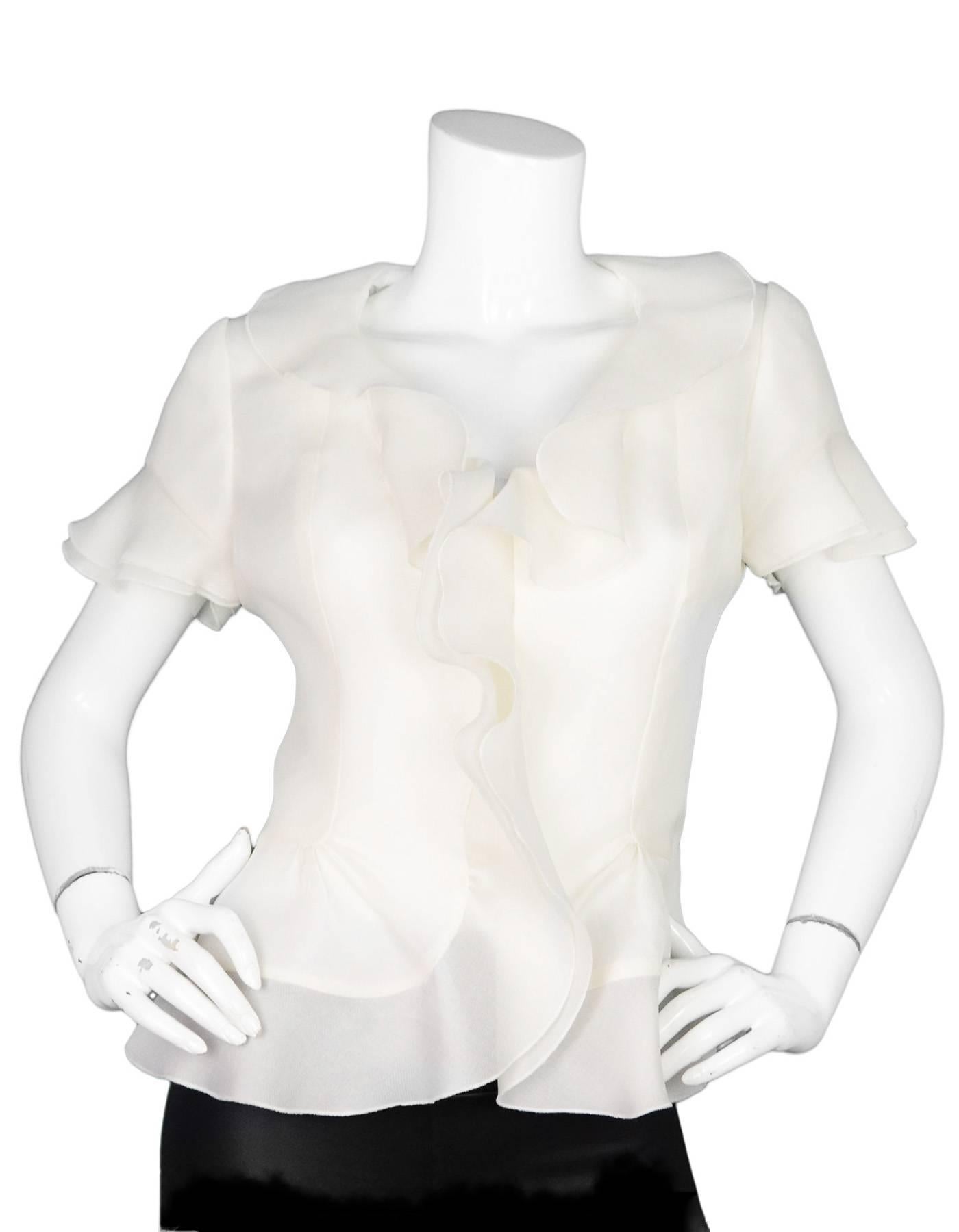 Jackie Rogers White Ruffle Organza Blouse  

Color: White
Composition: Believed to be a silk blend
Lining: White, believed to be a silk blend
Closure/Opening: Button down front
Exterior Pockets: None
Interior Pockets: None
Overall Condition:
