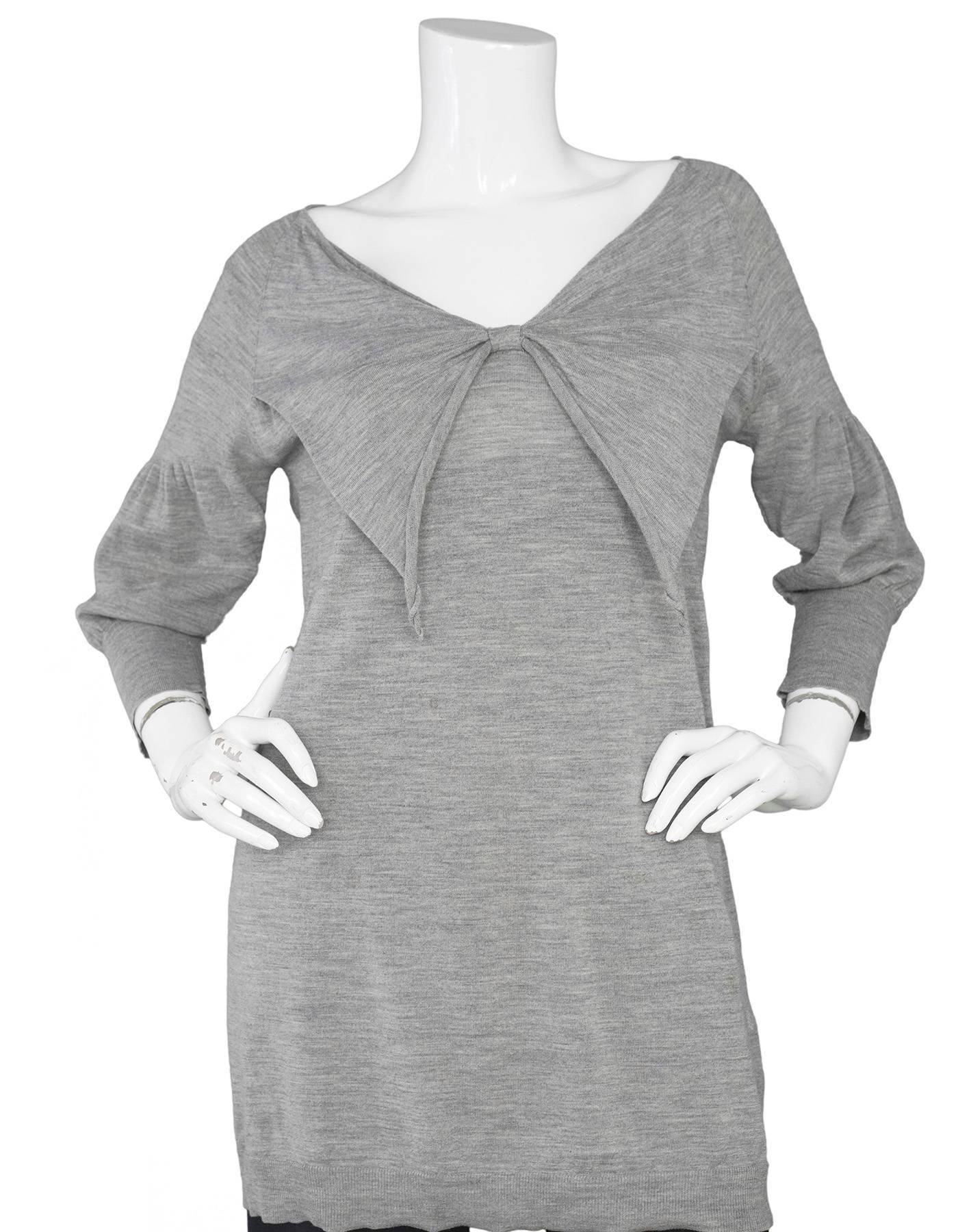 Miu Miu Grey Long Knit Tunic 
Features bow tied on front neckline

Made In: Italy
Color: Grey
Composition: Not given- believed to be a wool blend
Lining: None
Closure/Opening: Pull over
Exterior Pocket: None
Interior Condition: None
Overall