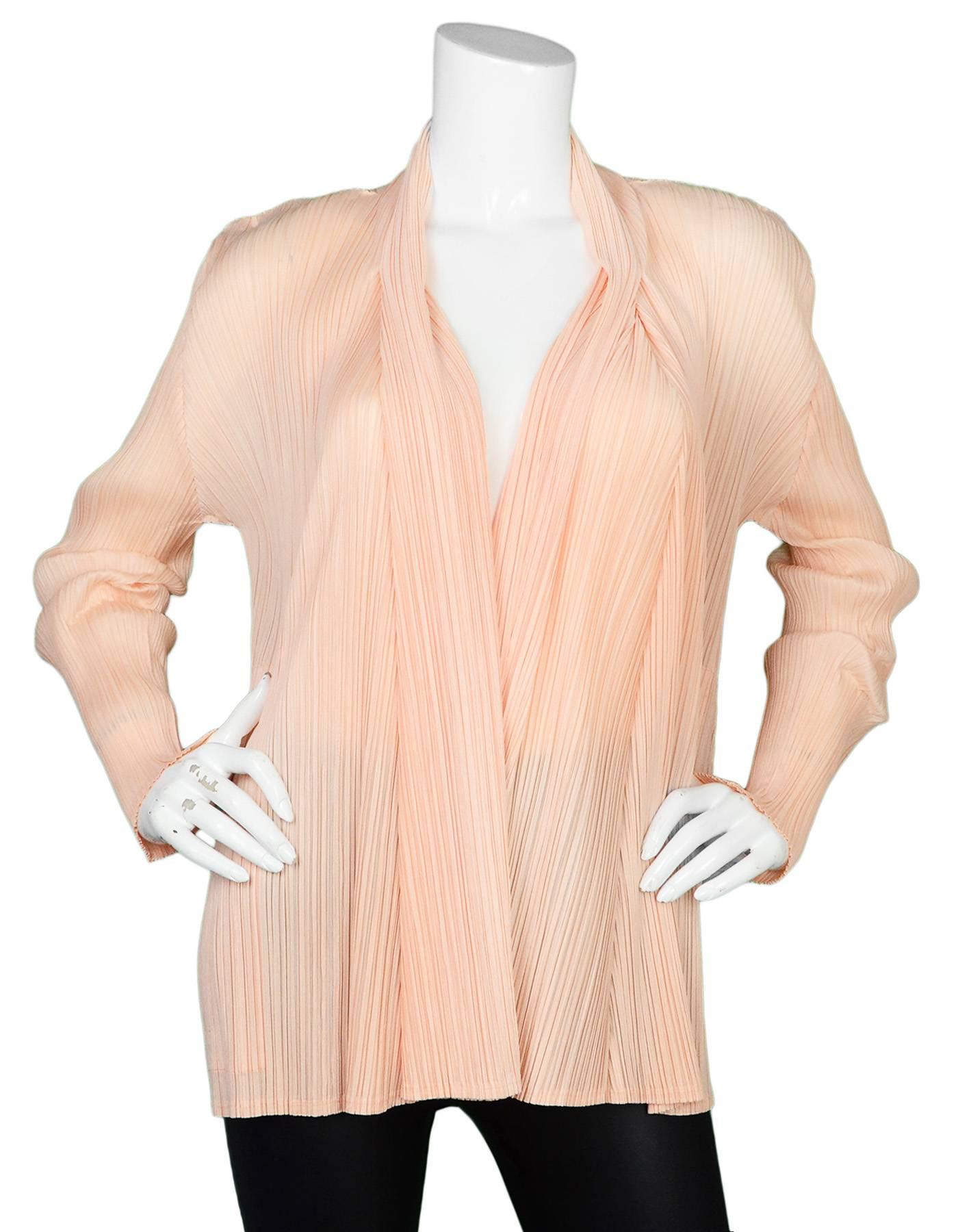 Pleats Please Peach Micro-Pleated Open Jacket
Features jagged cut hemline

Made In: Japan
Color: Peach
Composition: 100% polyester
Lining: None
Closure/Opening: Open front
Exterior Pockets: Two hip pockets
Interior Pockets: None
Overall Condition: