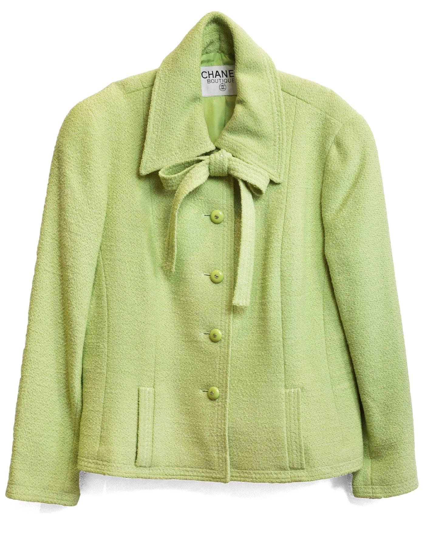 Chanel Chartreuse Boucle Jacket 
Features neck tie

Color: Chartreuse green
Composition: Not given- believed to be a wool blend
Lining: Chartreuse silk-blend
Closure/Opening: Button down front
Exterior Pockets: Two front pockets
Interior Pockets: