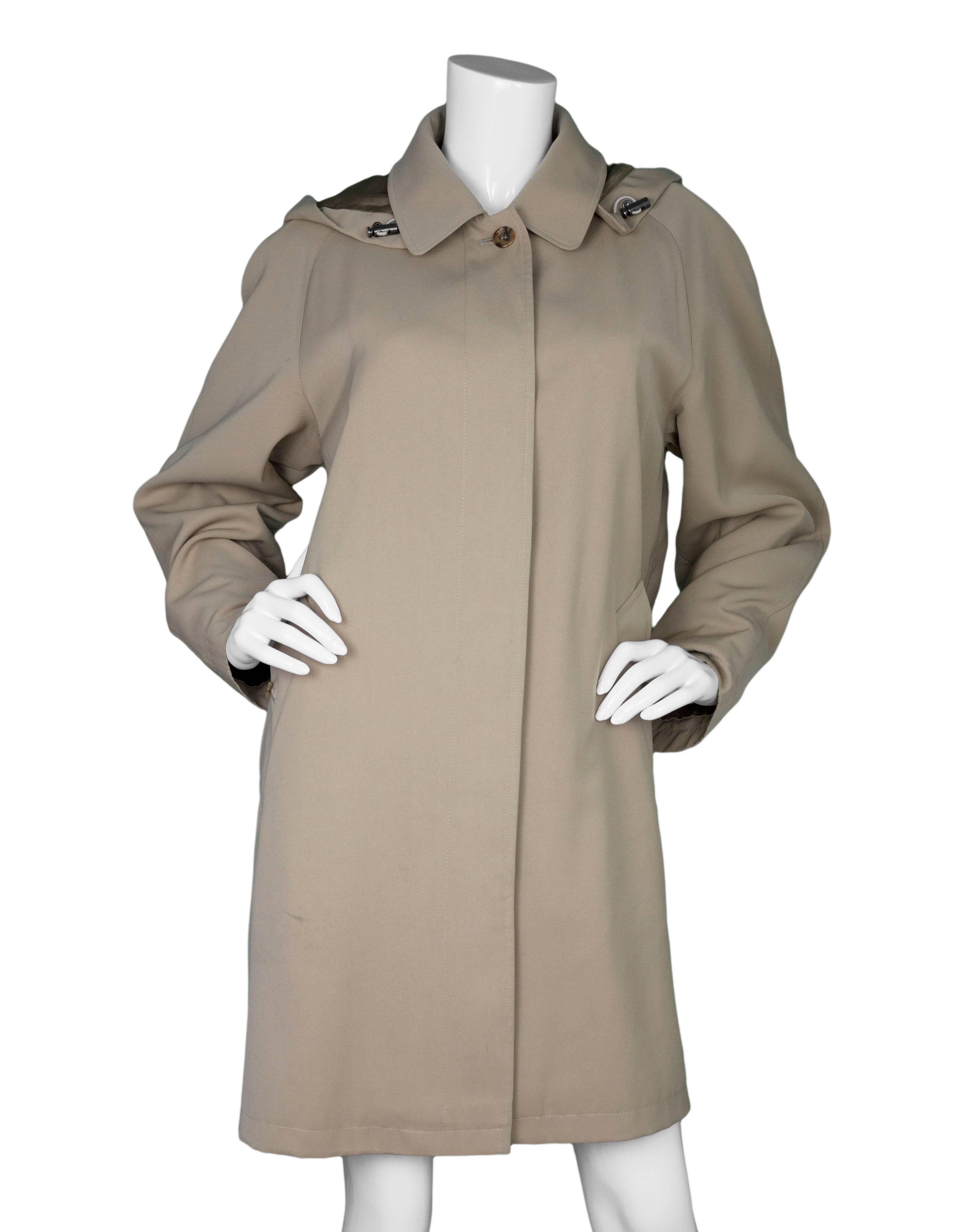 Burberry London Tan Trench Coat 
Features detachable button in hood and detachable zip around wool insert lining

Made In: 
Color: Tan
Composition: 100% polyester
Lining: Coat lining- 100% viscose, Insert Lining- 95% wool, 5% camel