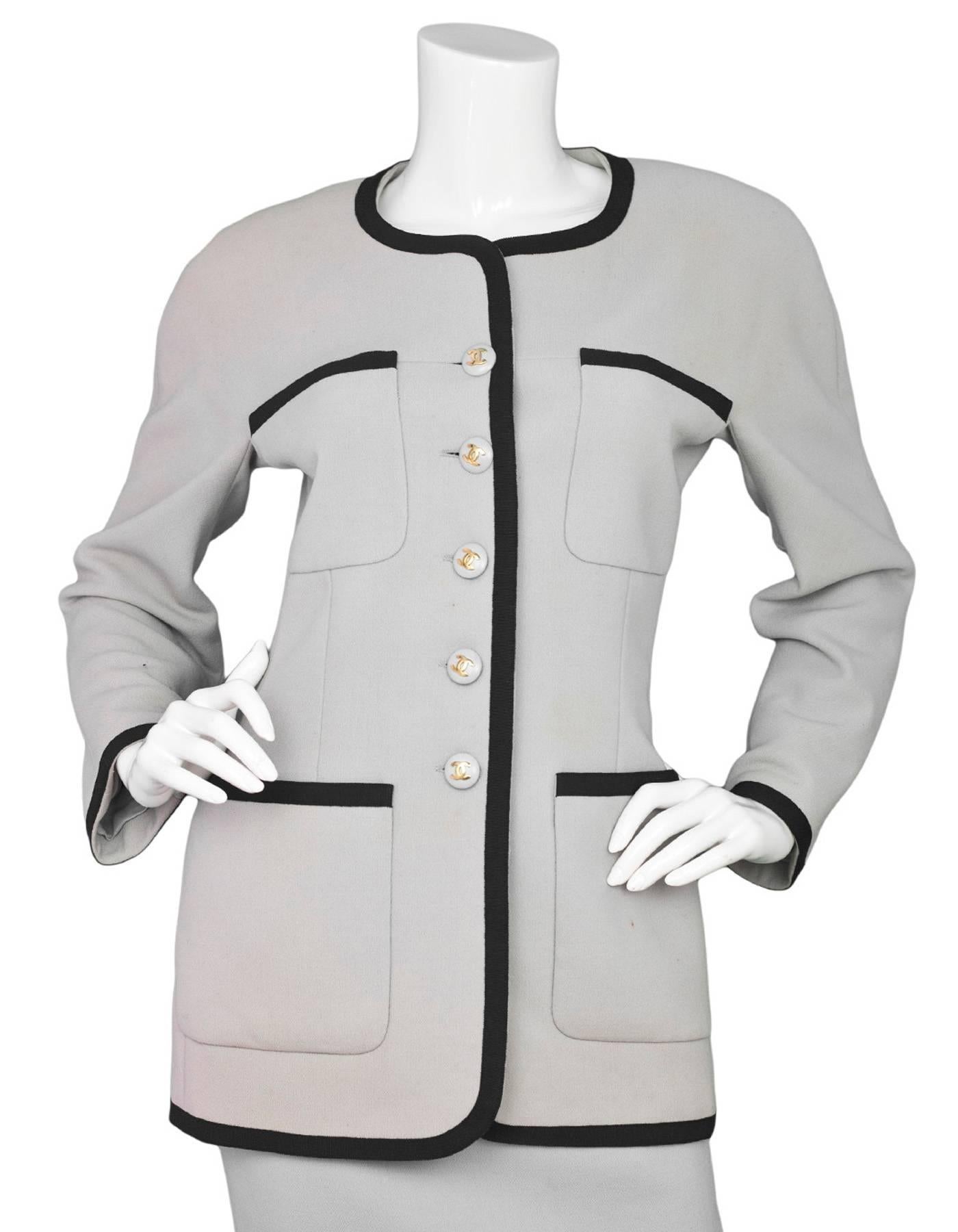 Chanel Grey & Black Wool Jacket 
Features black grosgrain trim and grey and goldtone CC detailed buttons

Made In: France
Color: Grey and black
Composition: 100% wool
Lining: Grey, 100% silk
Closure/Opening: Button down front
Exterior Pockets: Four