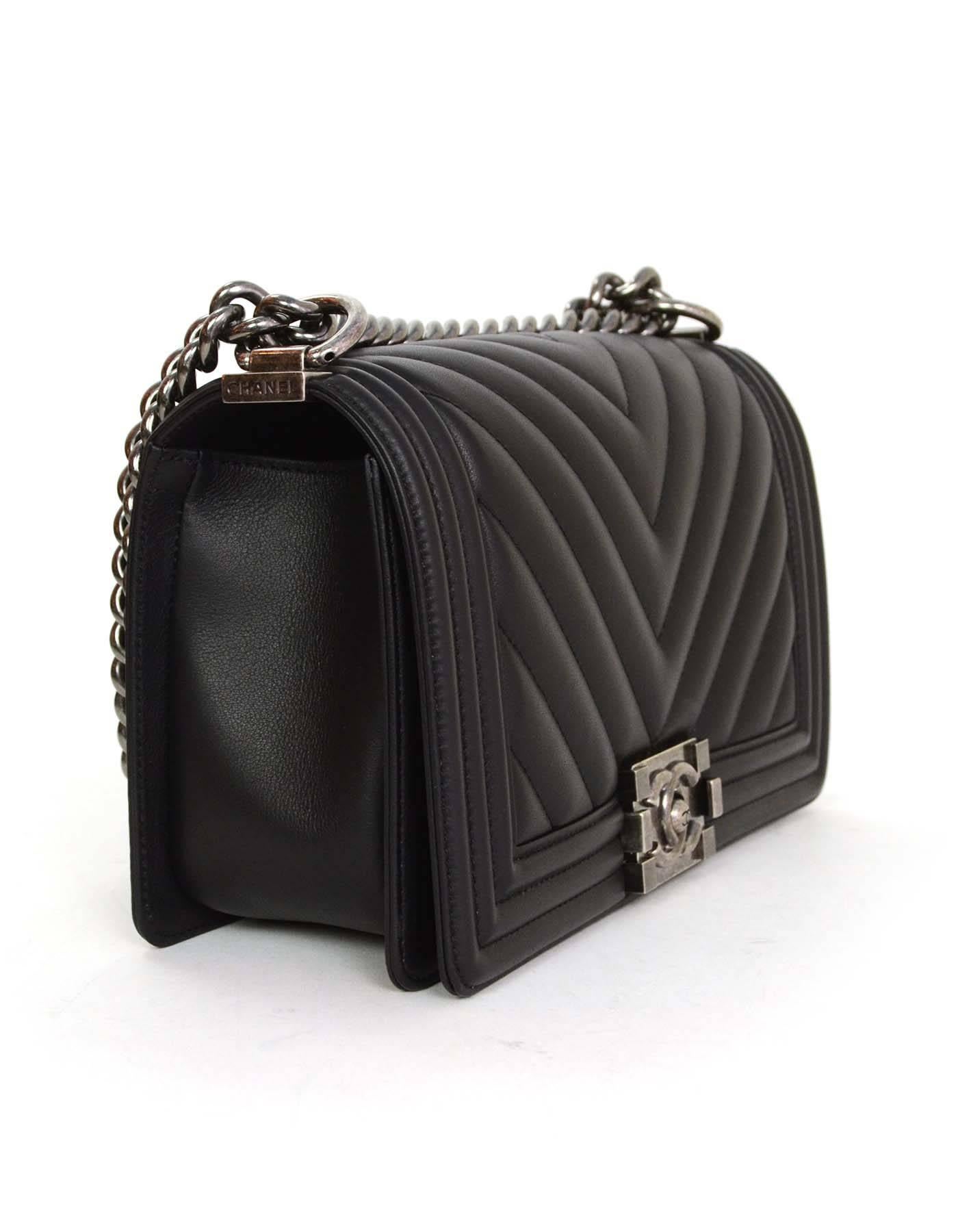 Chanel '16 Black Chevron Lambskin Old Medium Boy Bag 
Features adjustable shoulder strap and chevron quilting throughout front flap top and back panel of bag

Made In: France
Year of Production: 2016
Color: Black
Hardware: Oxidized
