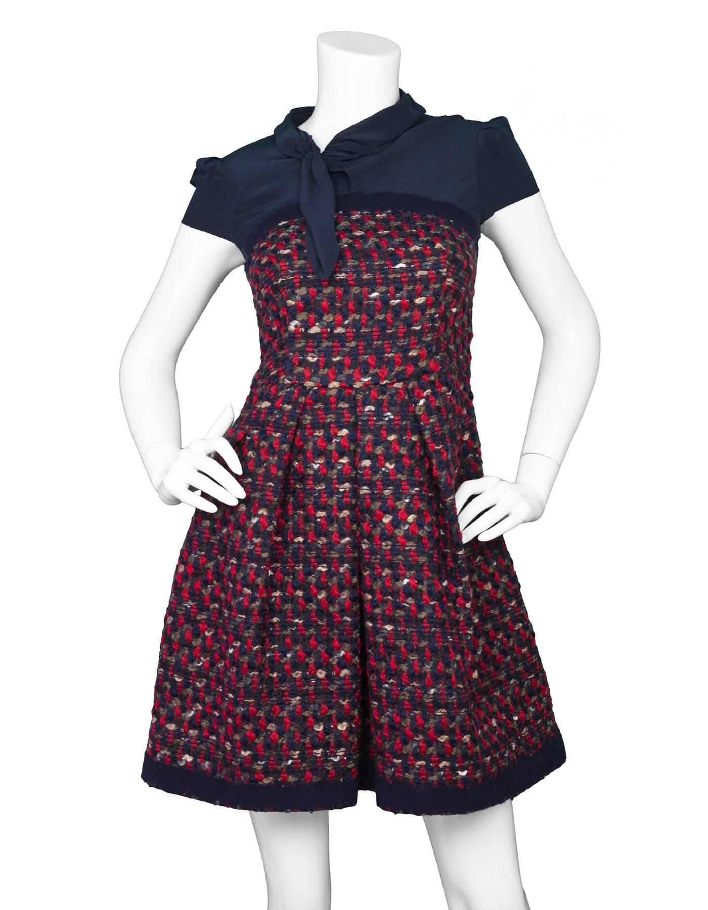 Prada Navy Silk & Red Tweed Cap Sleeve Dress 
Features bow detail at neckline

Made In: Italy
Color: Navy and red
Composition: Not given- believed to be 100% silk and 100% wool
Lining: Navy, silk
Closure/Opening: Back zip up closure with two