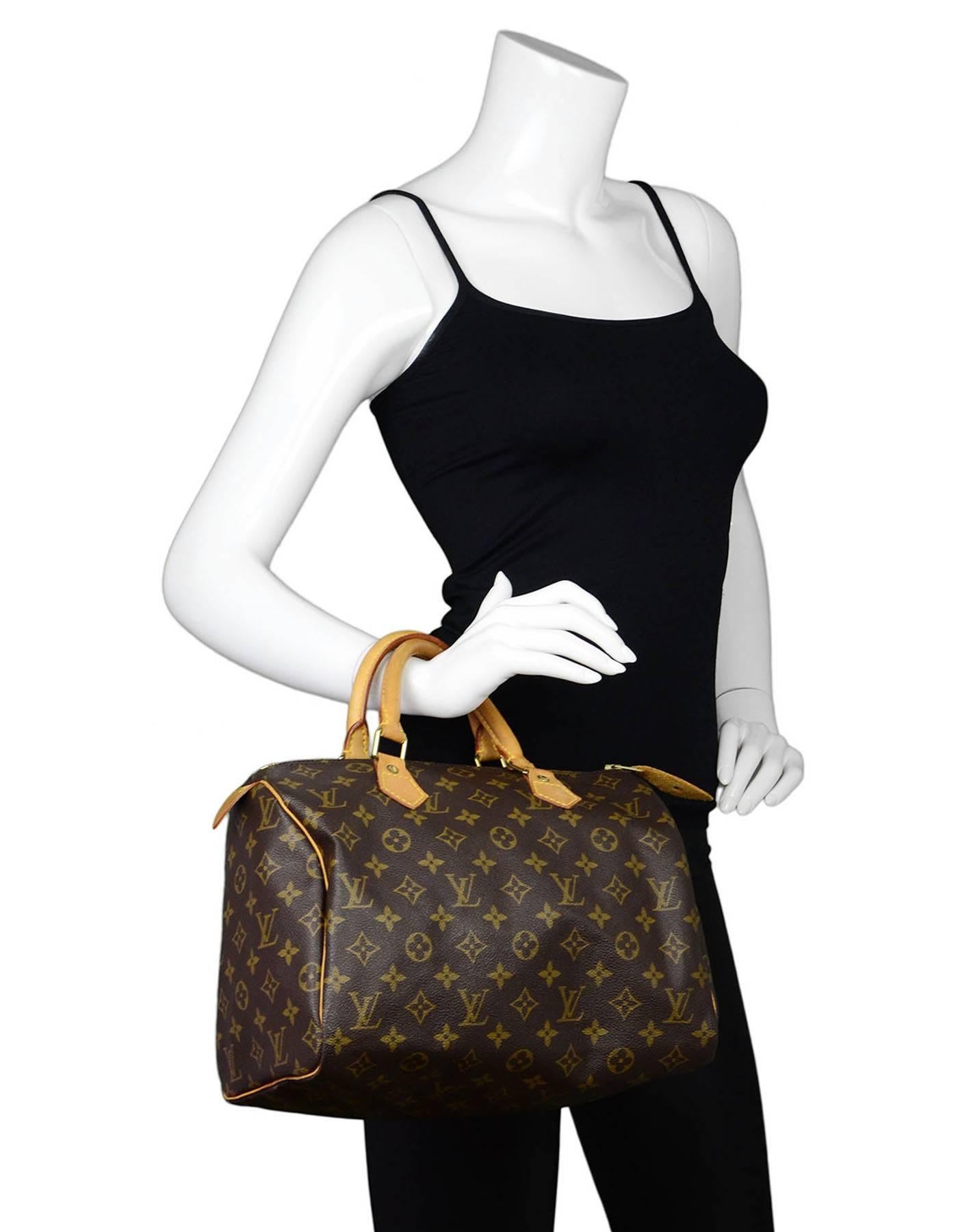 Louis Vuitton Vintage Monogram Speedy 30 Bag

Made In: USA
Year of Production: 1997
Color: Brown
Hardware: Goldtone
Materials: Leather and coated canvas
Lining: Brown canvas
Closure/Opening: Zip across top
Exterior Pockets: None
Interior Pockets: