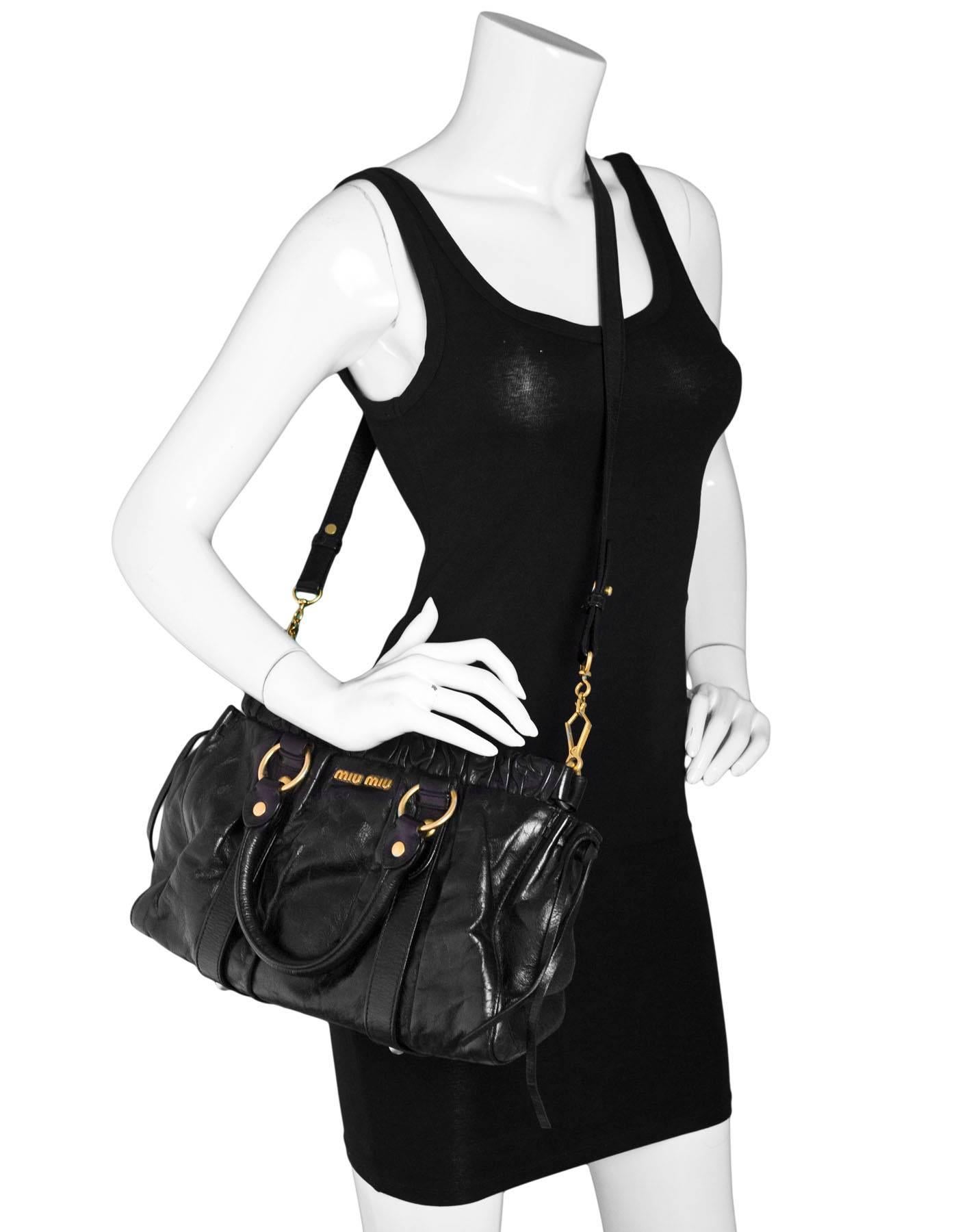 Miu Miu Black Ruched Leather Satchel

Made In: Italy
Color: Black
Hardware: Goldtone
Materials: Leather, metal
Lining: Black textile
Closure/Opening: Open top with center snap
Exterior Pockets: None
Interior Pockets: Zip wall pocket
Overall