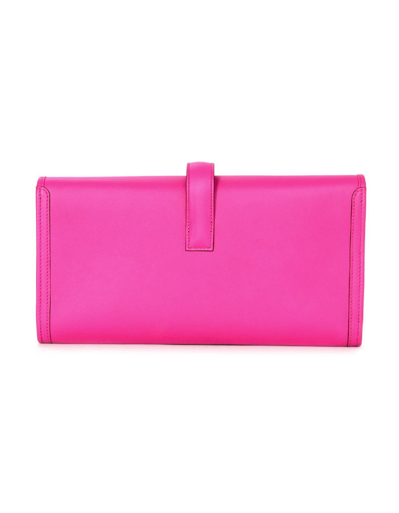 Hermes Magnolia Swift Leather Jige Elan 29 Clutch

Made In: France
Year of Production: 2018
Color: Magnolia pink
Hardware: None
Materials: Swift leather
Lining: Leather
Closure/opening: Flap top with strap that goes through H
Exterior Pockets: