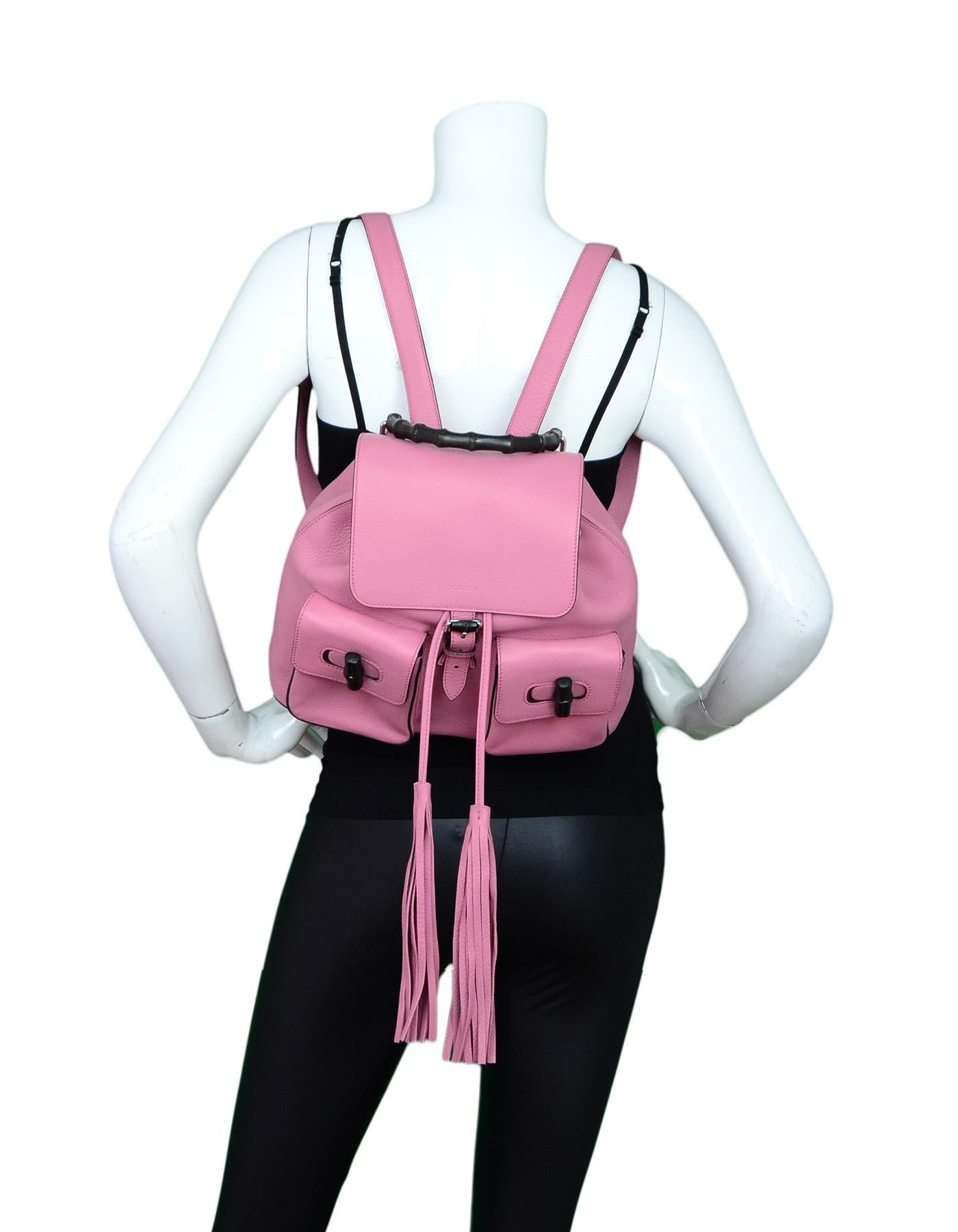 Gucci Glossy Pink Medium Bamboo Backpack Bag.  Features black bamboo twist lock pockets and bambo handle with pink tassel drawstring closure.

    Made In: Italy
    Color: 