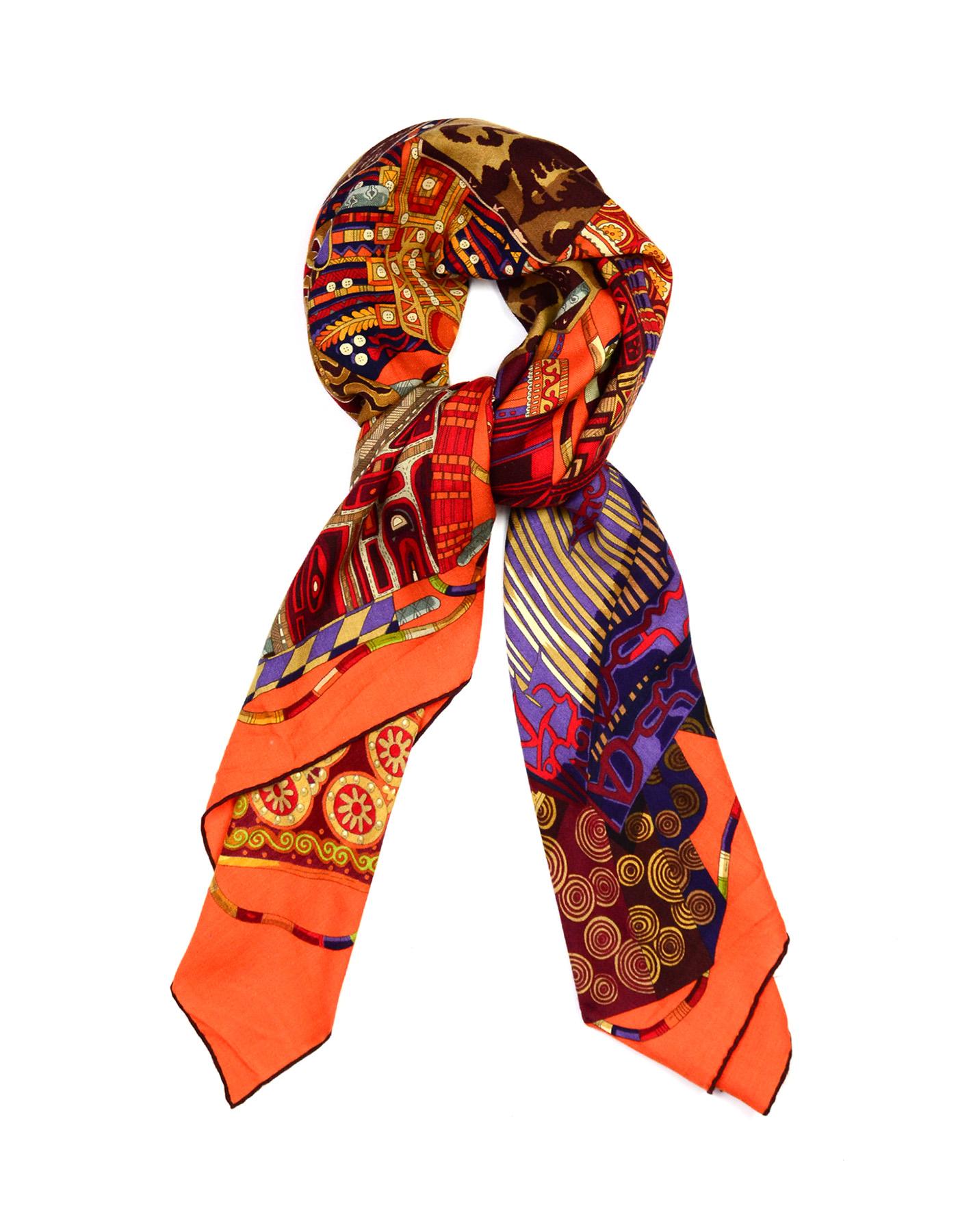 Hermes Orange Voyage En Etoffes Cashmere/Silk Shawl/Scarf 

Made In: France
Color: Orange, tan
Materials: 100% silk
Overall Condition: Very good pre-owned condition with exception of some pulls. 
Estimated Retail: $1,125 + tax

Measurements: 
54