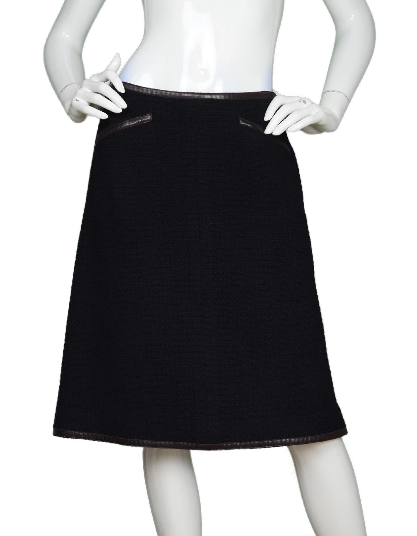 Chanel Black Wool Pencil Skirt W/ Leather Trim Sz 44. Skirt Only, Pictured With Matching Jacket, Item #6527-17.

Made In: France
Color: Black with brown trim
Materials: 100% wool
Lining: 90% silk, 10% spandex
Opening/Closure: Hidden back zip with
