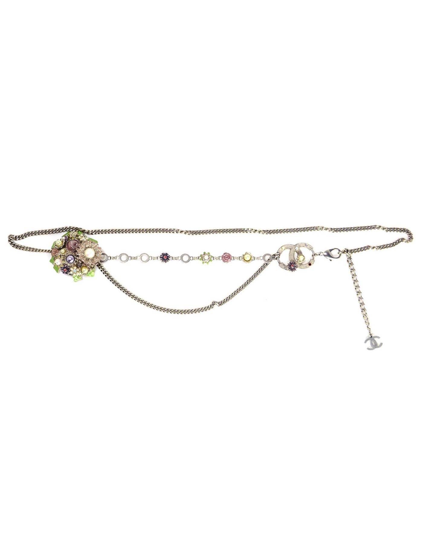 Chanel Silver Flower & CC Chain Link Belt
Features faux pearls and rhinestone filled flower pendants and one hanging chain link tier

Made in: France
Year of Production: 2005
Stamp: 05 CC P
Closure: Lobster claw clasp
Color: Silver, ivory, green