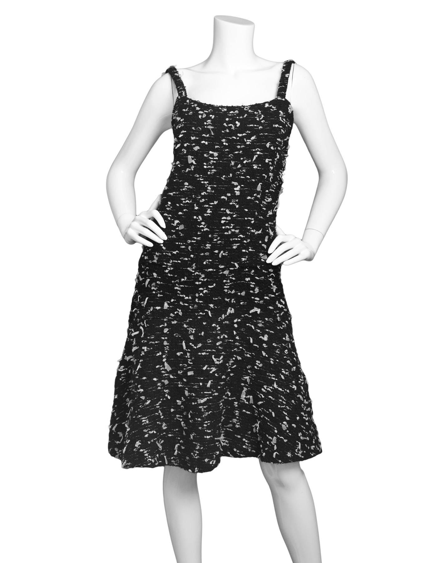 Chanel Black Tweed Sleeveless Dress

Made In: France
Year of Production: 2002
Color: Black
Composition: 72% Wool, 8% Nylon, 8% Acrylic, 7% Rayon, 3% Polyethylene, 90% Silk 10%
Lining: Black, 90% Silk 10% Spandex
Closure/opening: Back center zip