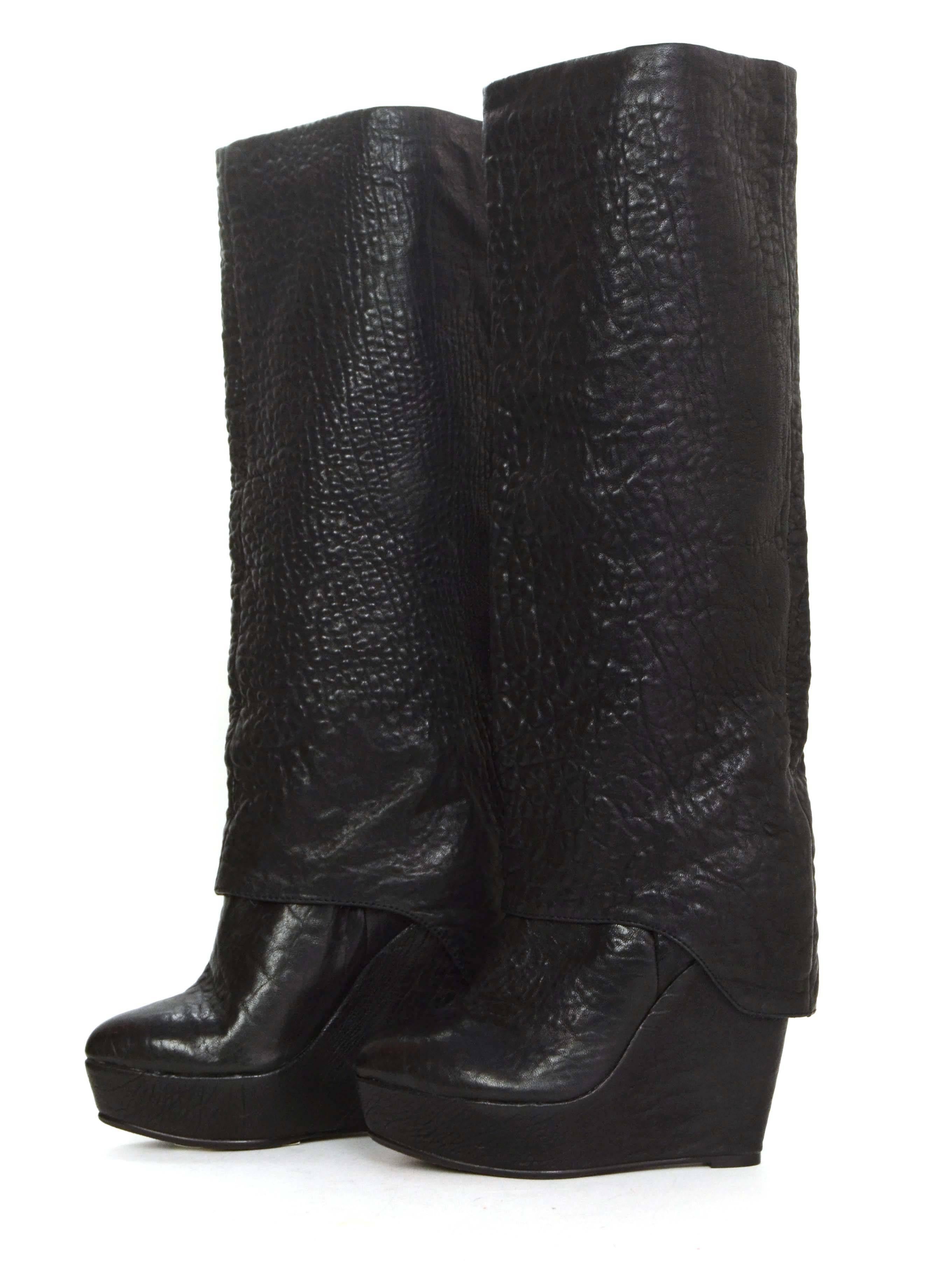 Elizabeth and James Black Pebbled Leather Platform Wedge Boots
Made In: China
Color: Black
Materials: Leather
Closure/Opening: Pull on
Sole Stamp: Elizabeth and James Vero Cuoio 6 ½ B
Overall Condition: Excellent pre-owned condition with the