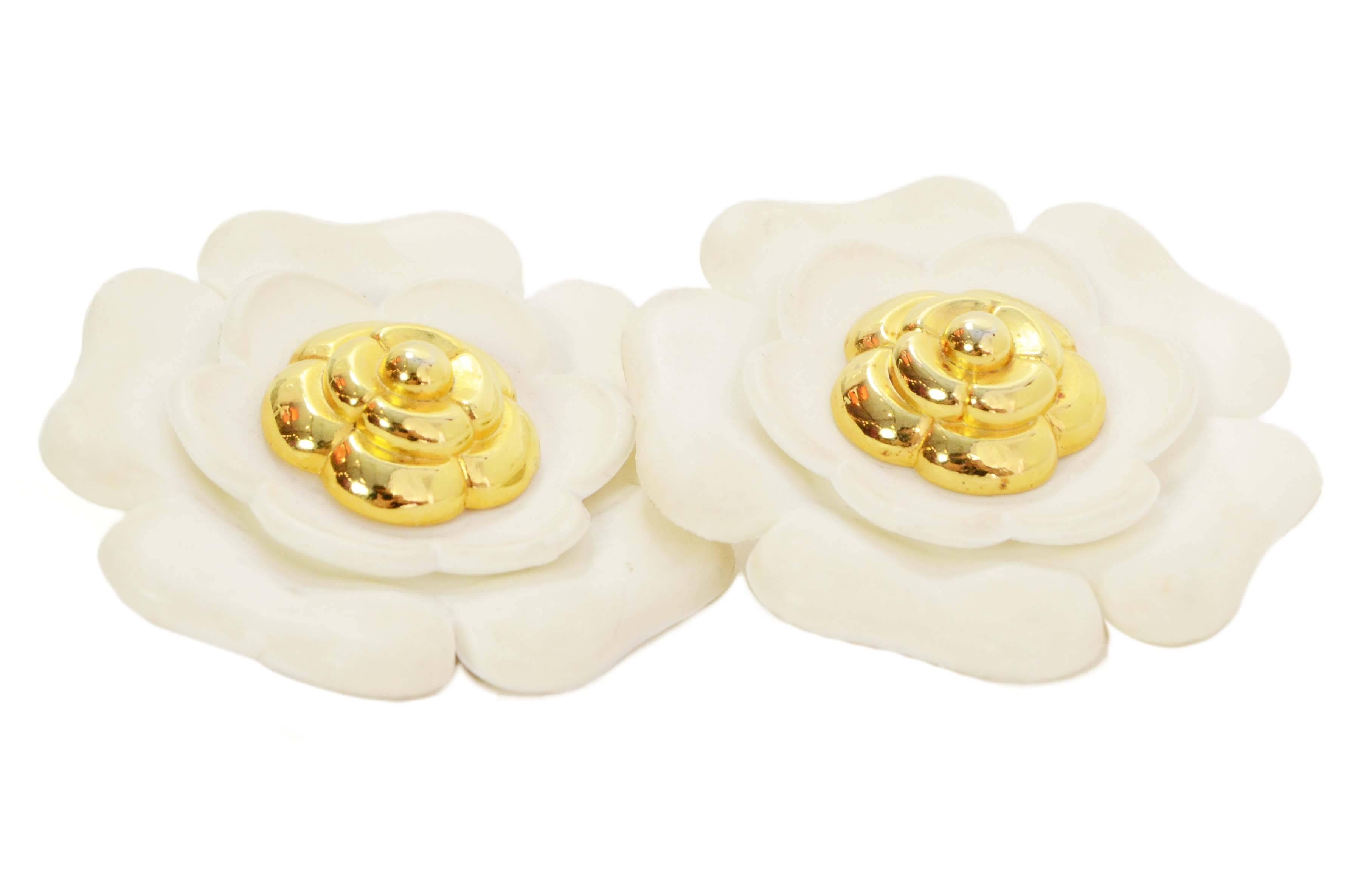 Chanel Vintage ‘60s Ivory & Gold Camelia Flower Clip On Earrings
Features smaller goldtone flower in center of larger ivory flower
Year of Production: 1950’s-1960’s
Color: Ivory and goldtone
Materials: Resin and metal
Closure: Clip on
Stamp: