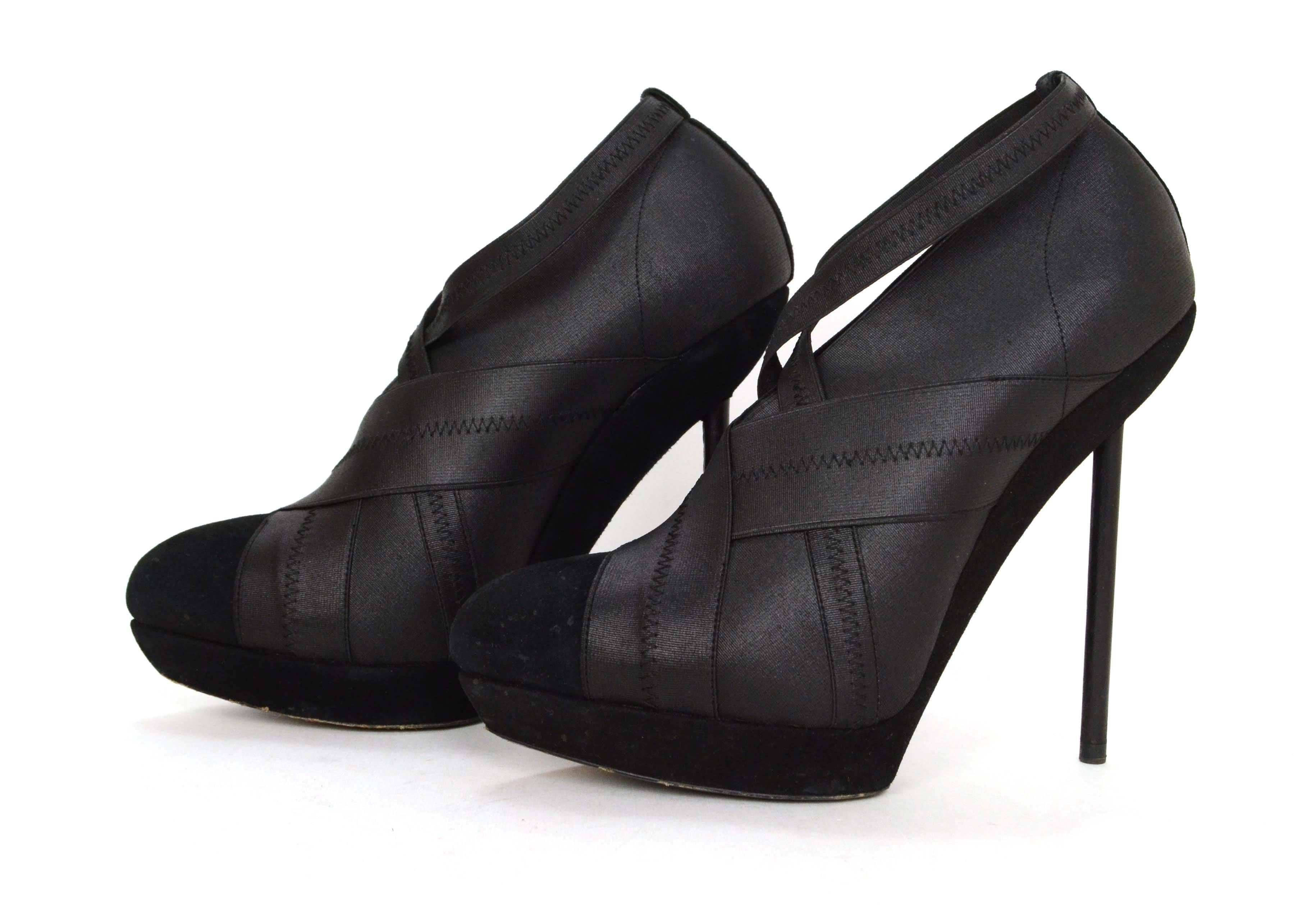 Yves Saint Laurent YSL Black Bandage Stiletto Pumps
Features suede platform and toe cap
Color: Black
Materials: Suede and elastic
Closure/Opening: Pull on
Sole Stamp: Not legible- has been worn off
Overall Condition: Excellent pre-owned