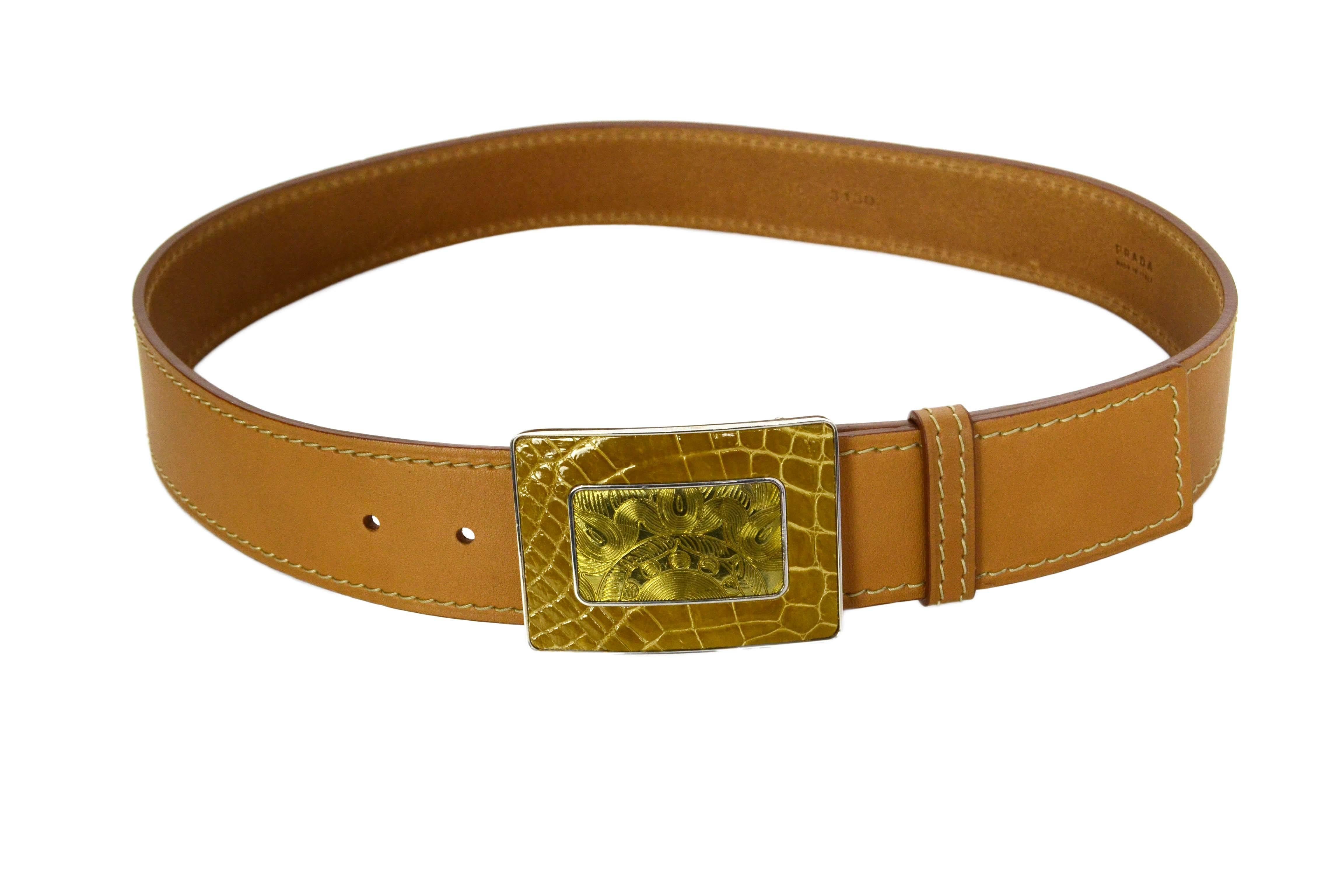 Prada Tan Leather Belt
Features glazed over crocodile belt buckle
Made In: Italy
Color: Tan and silvertone
Materials: Leather, metal and croc
Closure/Opening: Stud and notch closure
Serial Number/Date Code: 1C 3130
Overall Condition: