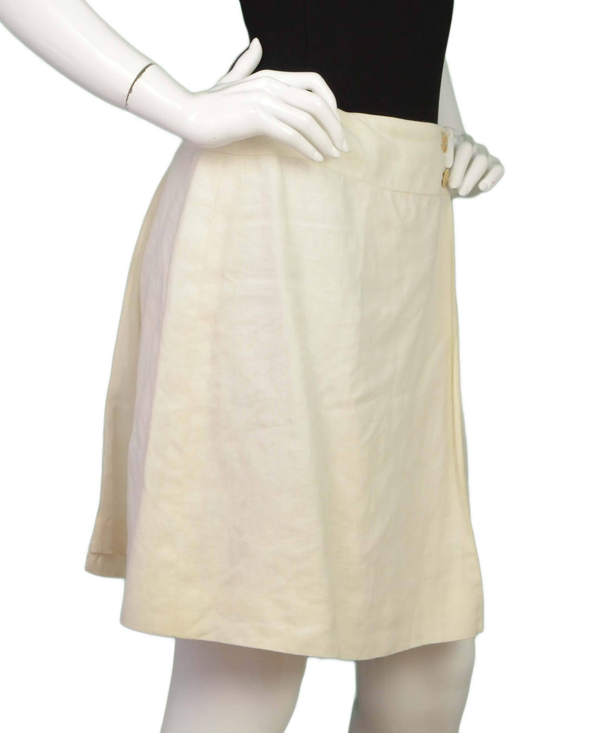 Chanel Ivory Linen Wrap Skirt
Features wooden “Chanel Paris” buttons
Made In: France
Year of Production: 2000
Color: Ivory
Composition: 100% linen
Lining: Ivory, 100% silk
Closure/Opening: Wrap around with double button closure on either side