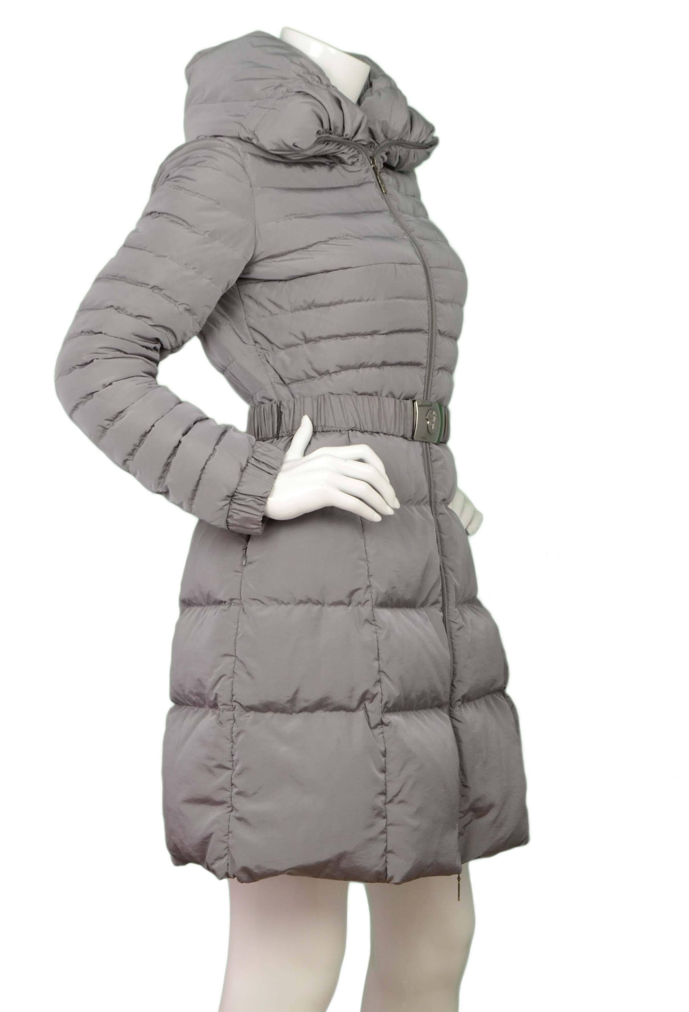 Moncler Grey Quilted Down Belted Coat 
Features hood
Made In: Moldavia
Color: Grey
Composition: 71% Nylon, 29% polyester
Lining: Grey, 100% nylon
Closure/Opening: Zip up front with elastic waist belt
Exterior Pockets: Two side zipper