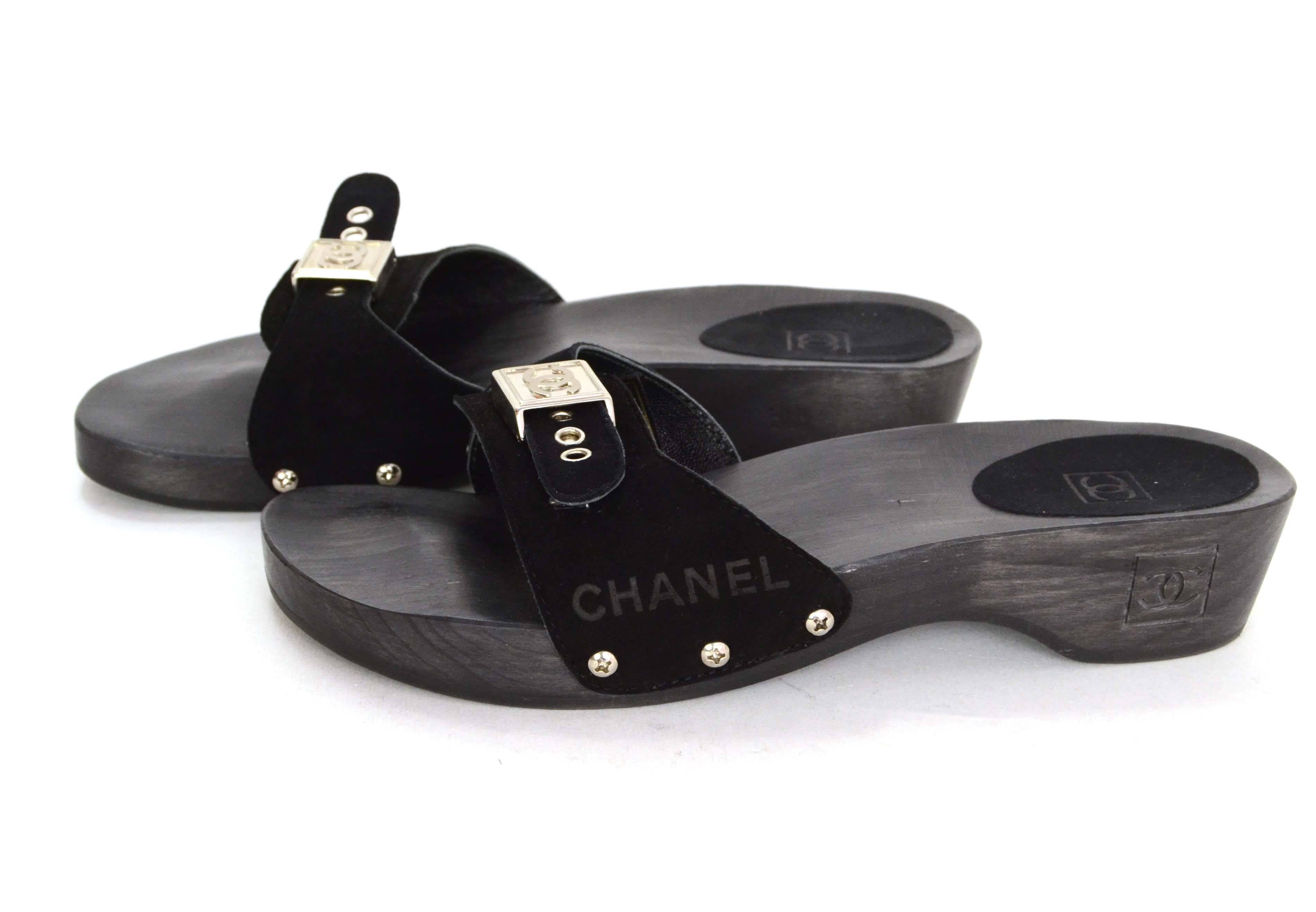 Chanel Black Suede & Wood Dr. Scholl's Open Toe Mules 
Features silvertone buckle and CC clasp on toe strap
Made In: Spain
Color: Brown and black
Materials: Wood and suede
Stamp: CC
Overall Condition: Excellent pre-owned condition with the
