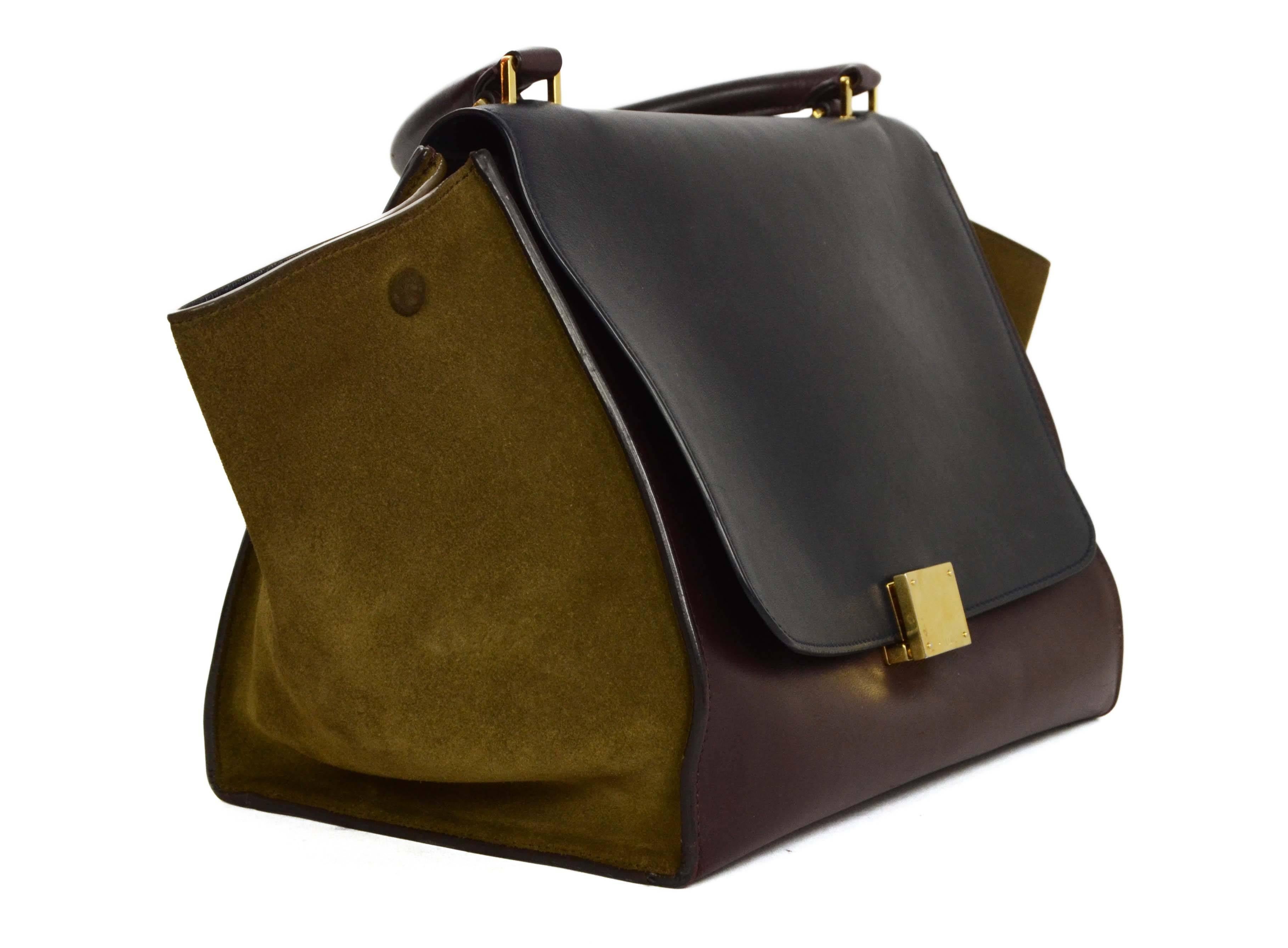 Celine Tri-Color Leather & Suede Trapeze Bag 
*Note: Missing long shoulder strap*
Made In: Italy
Color: Burgundy, navy, olive green and goldtone
Hardware: Goldtone
Materials: Leather, suede and metal
Lining: Navy leather
Closure/Opening: Flap