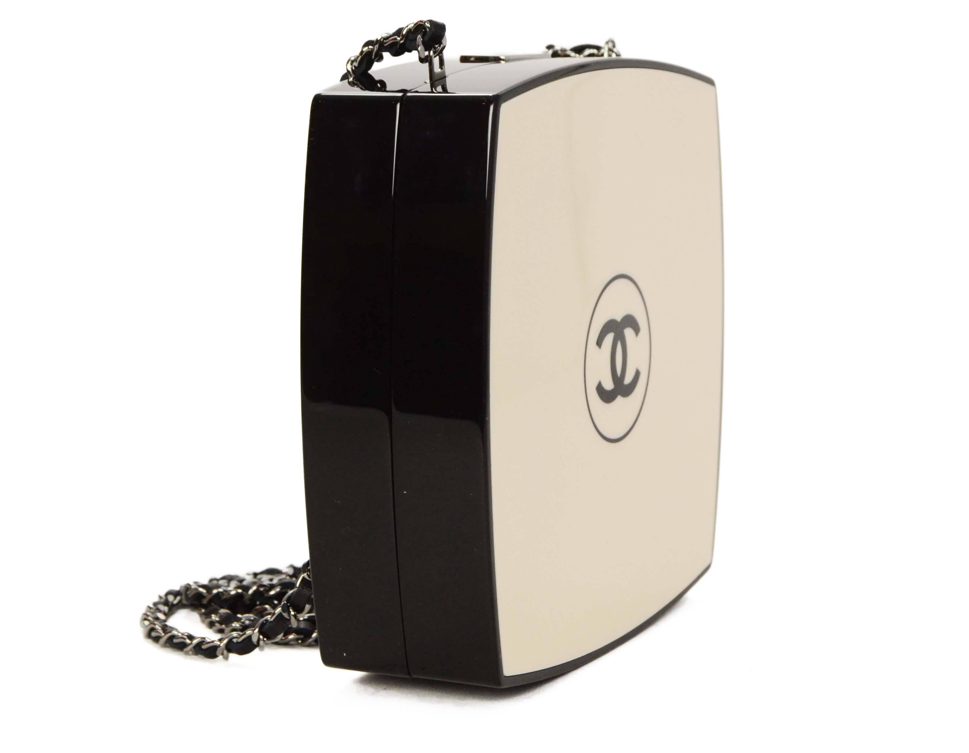 Chanel '15 Beige & Black Compact Clutch 
Features optional mini leather woven chain link shoulder/crossbody strap
Made In: Italy
Year of Production: 2015
Color: Black and beige
Hardwarwe: Ruthenium
Materials: Resin, leather and metal
Lining: