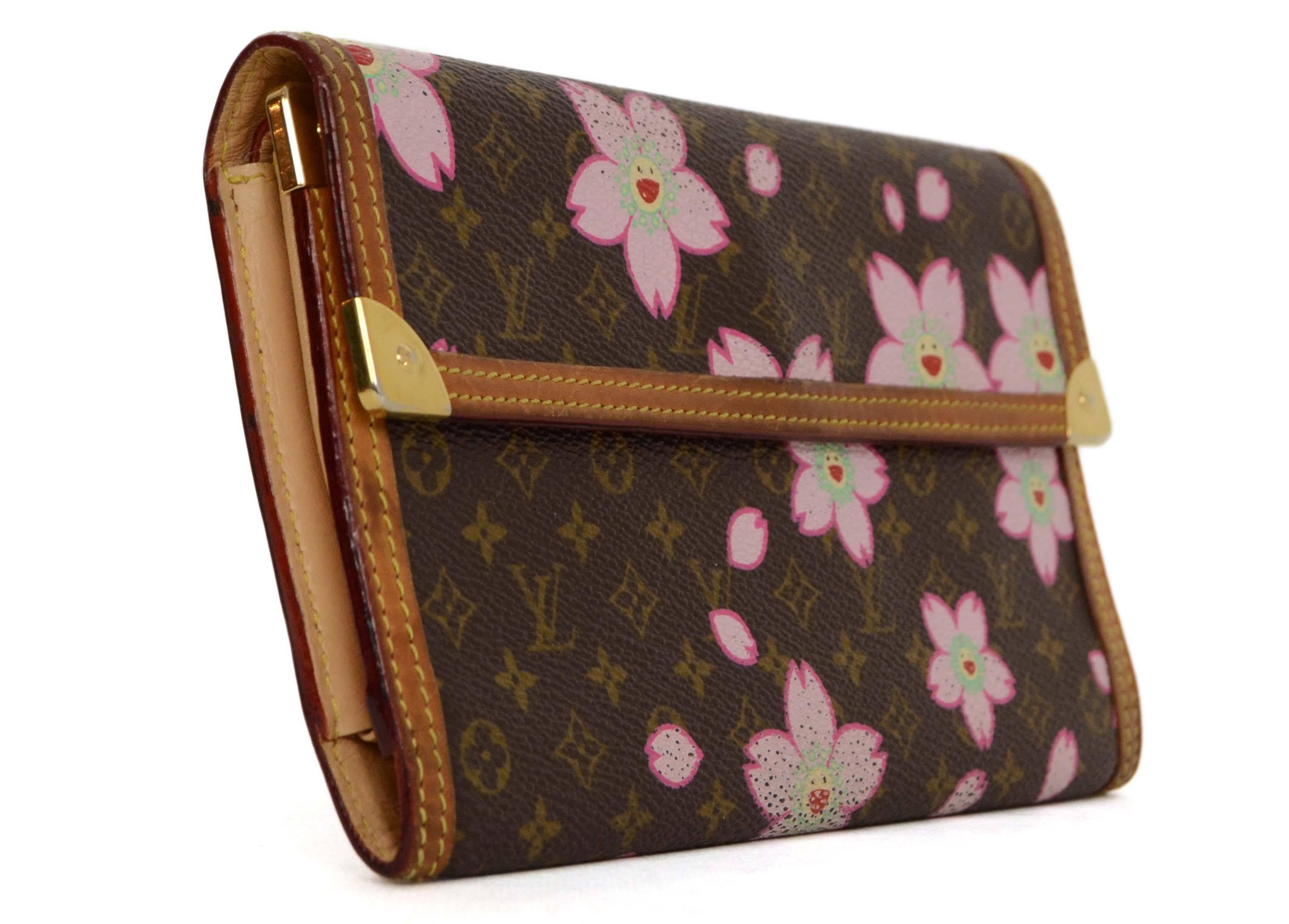 Louis Vuitton Monogram Cherry Blossom Long Wallet 
Features small pink cherry blossoms printed throughout
Made In: France
Year of Production: 2003
Color: Brown, tan, pink and goldtone
Hardware: Goldtone
Materials: Coated canvas, leather and