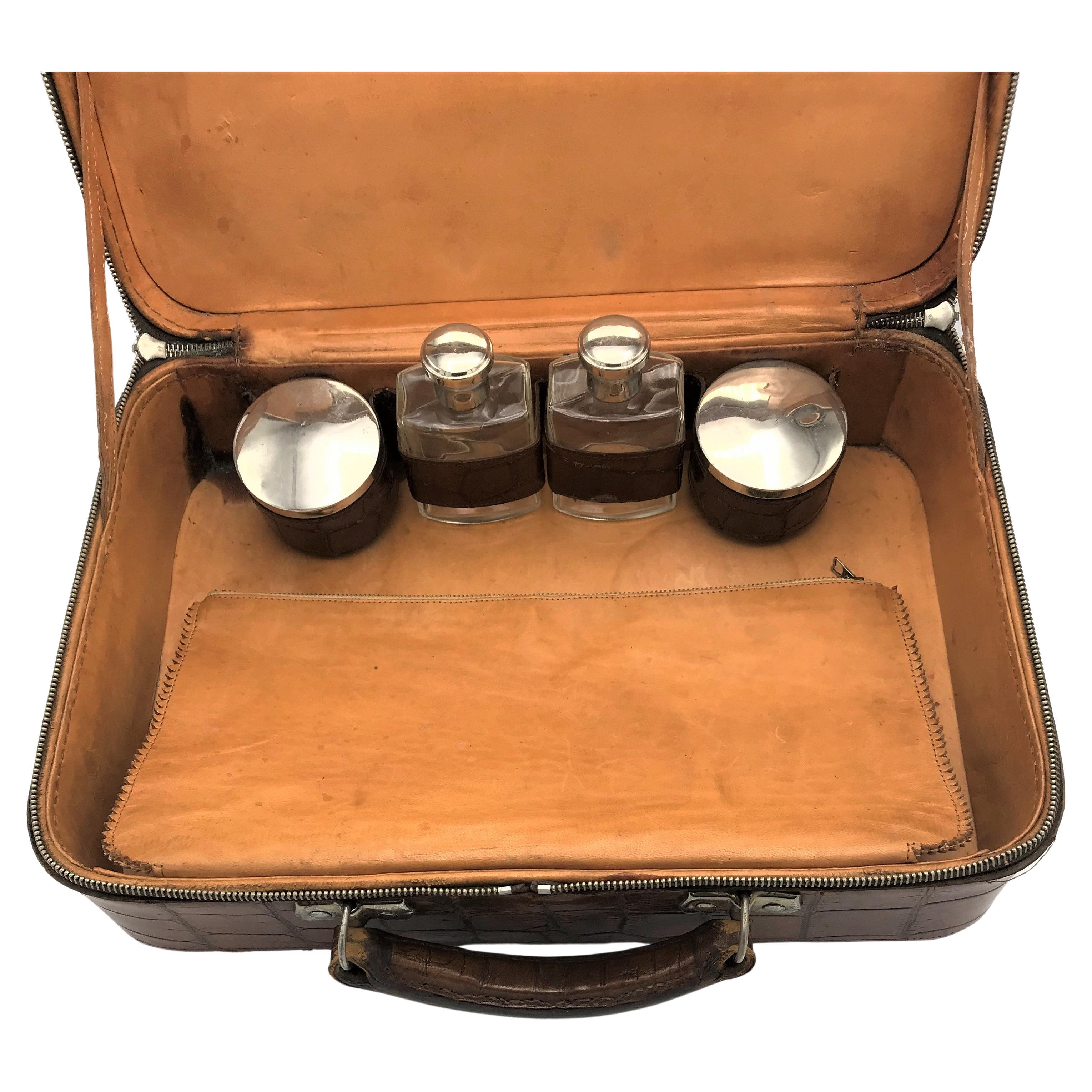 A very rare and unique beauty case made from wild crocodile from the last century. Interior made of natural leather with 2 bottles and glass jars. An integrated pocket for other utensils. A mirror was important when traveling, unfortunately it is a