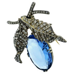 Vintage Eisenberg pin in the style of a blue fruit, leaves, sterling gold plated, 1940s