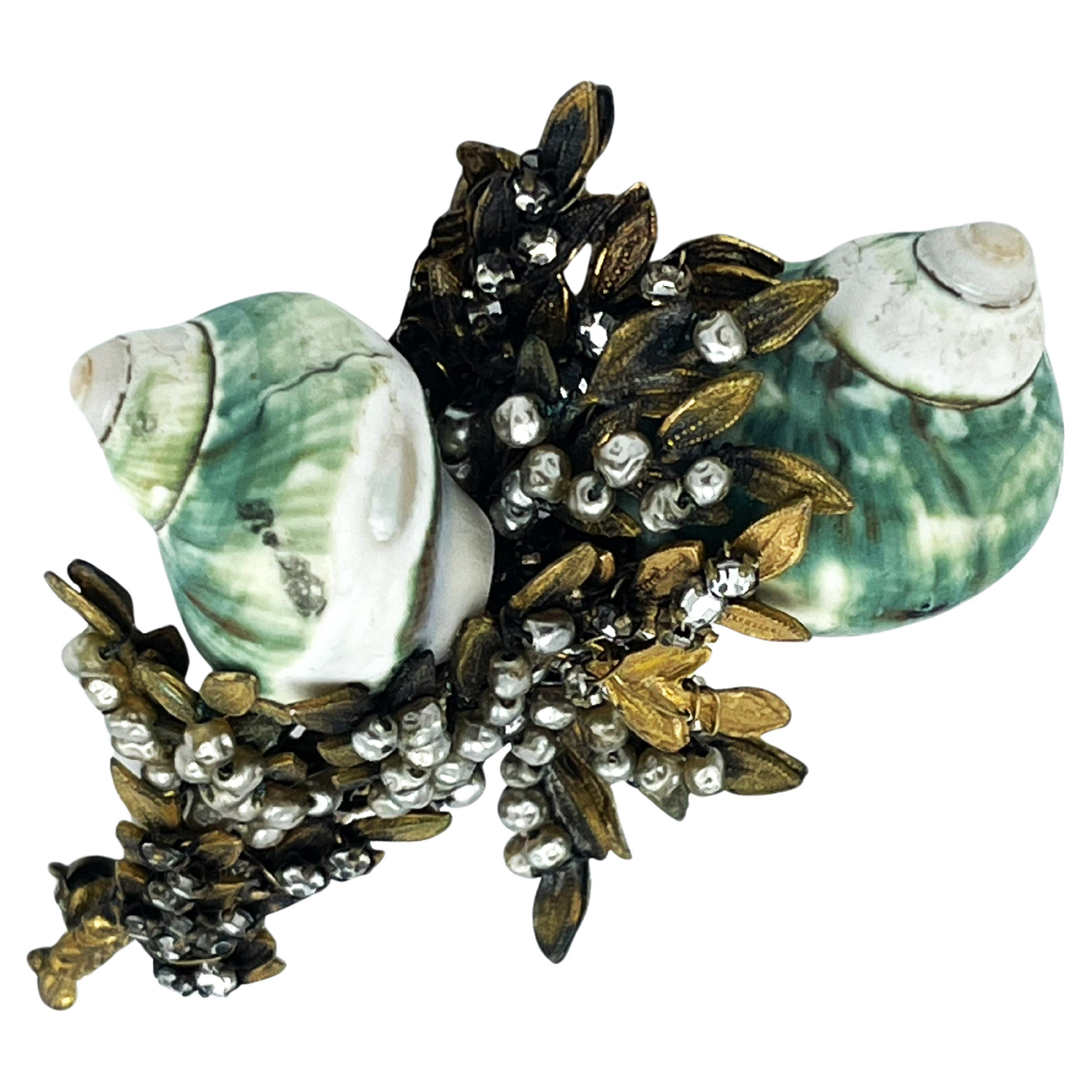 The early jewelry by Miriam Haskell often reflected themes from nature that would be carried throughout the history of the company. Vines, leaves, flowers, butterflies and here now snails!
Brooch with matching earrings, decorated with snails, leaves