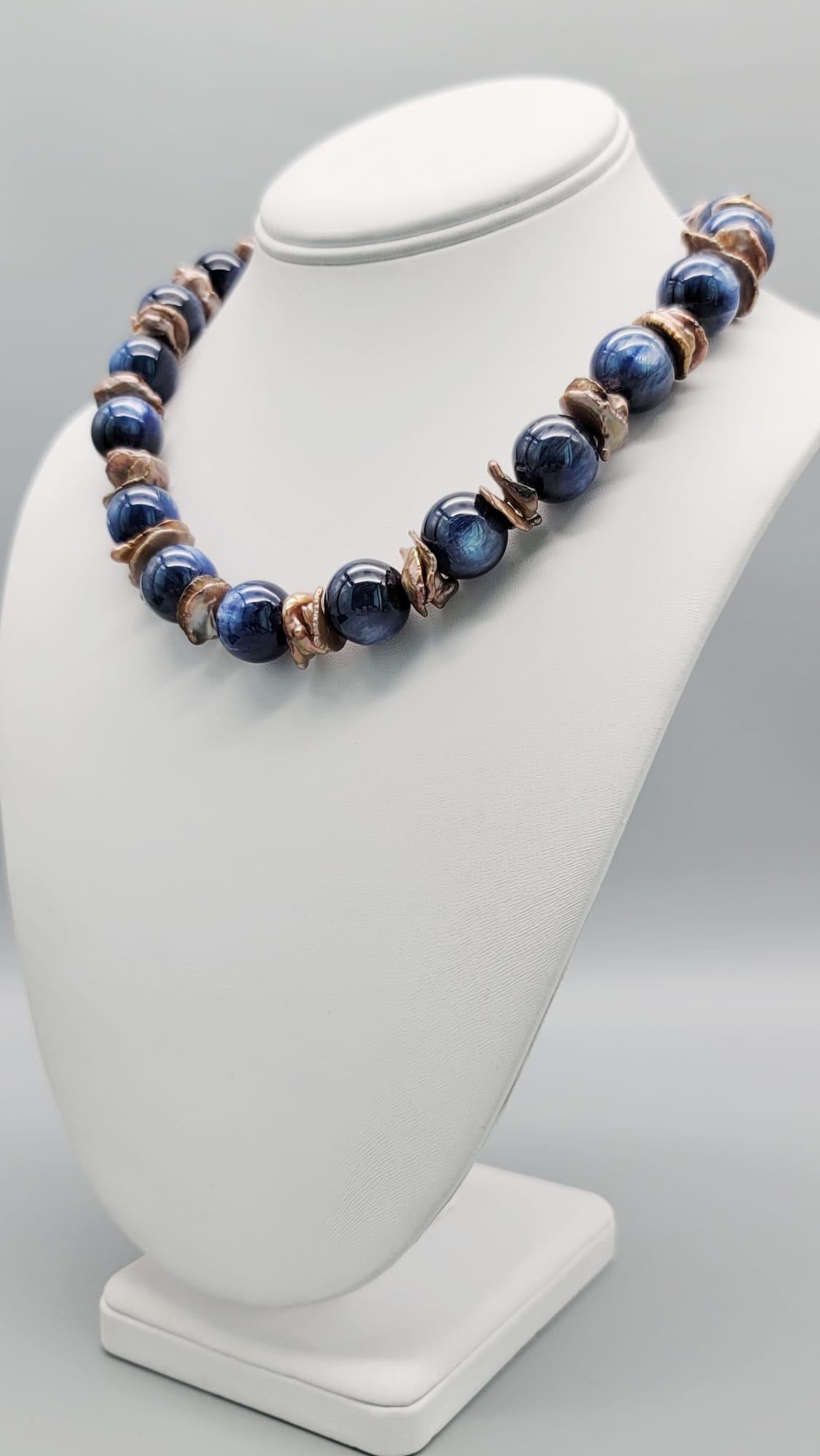 One-of-a-Kind

Rich blue Kyanite is matched with center-drilled bronze Keshi Pearls To surround a specimen piece of Jasper clasp. The combination of rich blue and creamy beige is an unusually felicitous one.
Silk hand-knotted
Approx: 18 inches