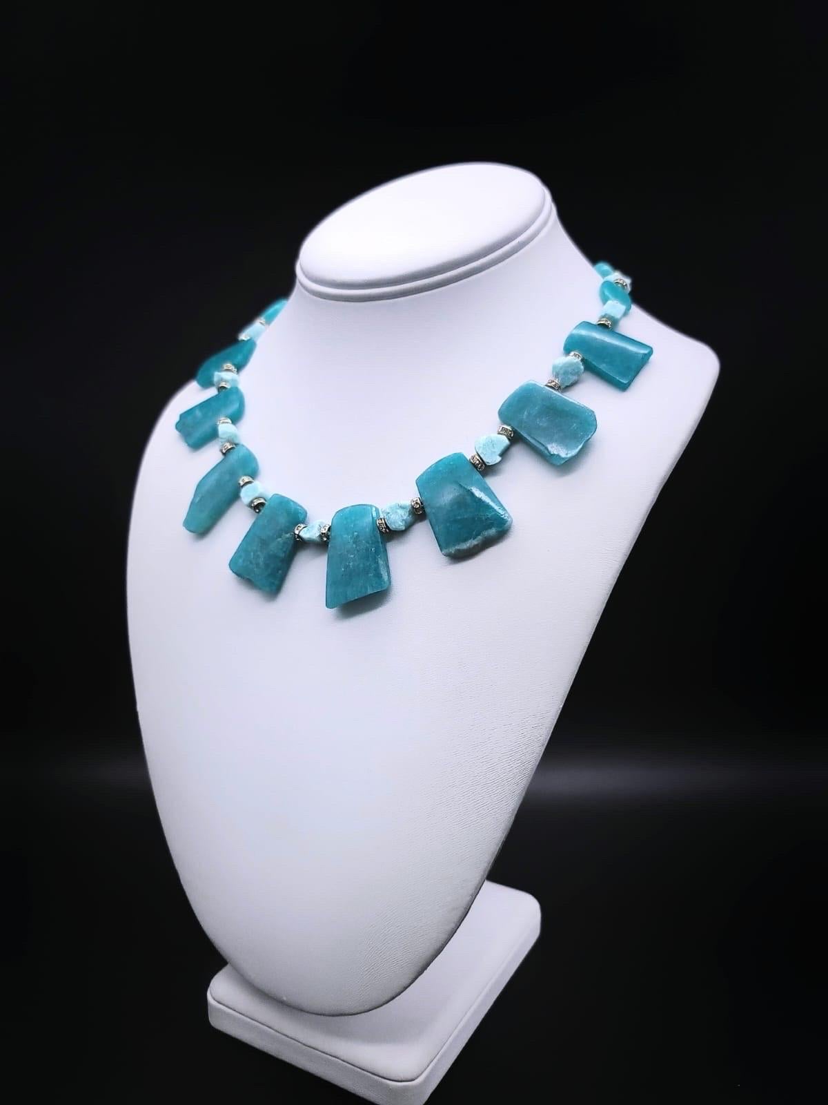 One-of-a-Kind

Richly colored Amazonite necklace. These highly polished plates were purposely left rough across the bottom to show that the color was saturated, the spacers are tumbled Amazonite of a lighter hue. Amazonite, often called the “peace