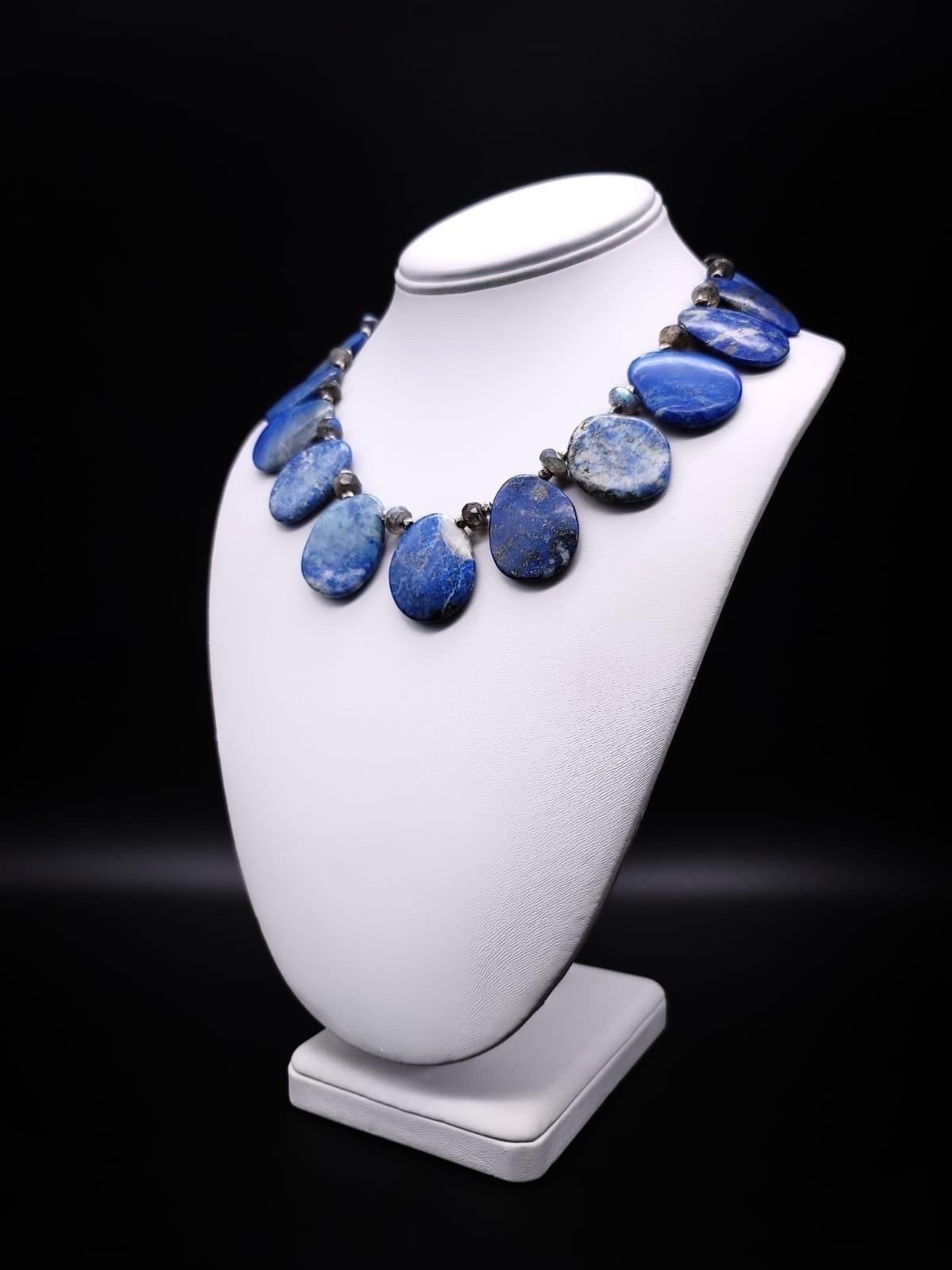 One-of-a-Kind

Indulge in the timeless elegance of the Lapis Lazuli stone with this stunning collar necklace. The mottled Lapis plates are polished to perfection, showcasing a beautiful array of gray shades within the stone. The faceted Labradorite