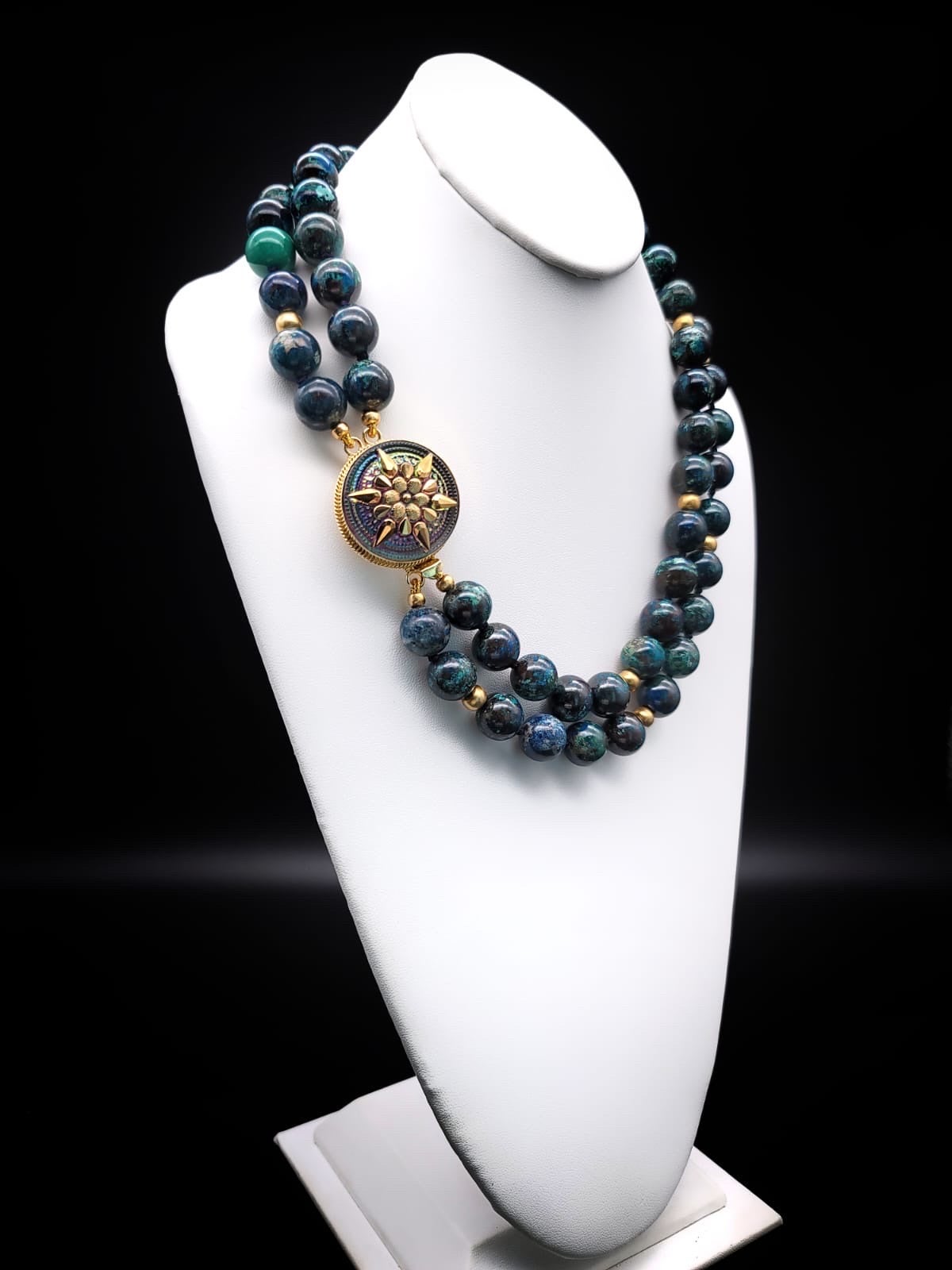 One-of-a-Kind

Chrysocolla double-strand matching 16mm bead
Is it blue? Is it green? Is it cyan.? Is it black? Well, it is all those colors sometimes in a single bead. There are those who say, that looking at a chrysocolla bead is like looking at