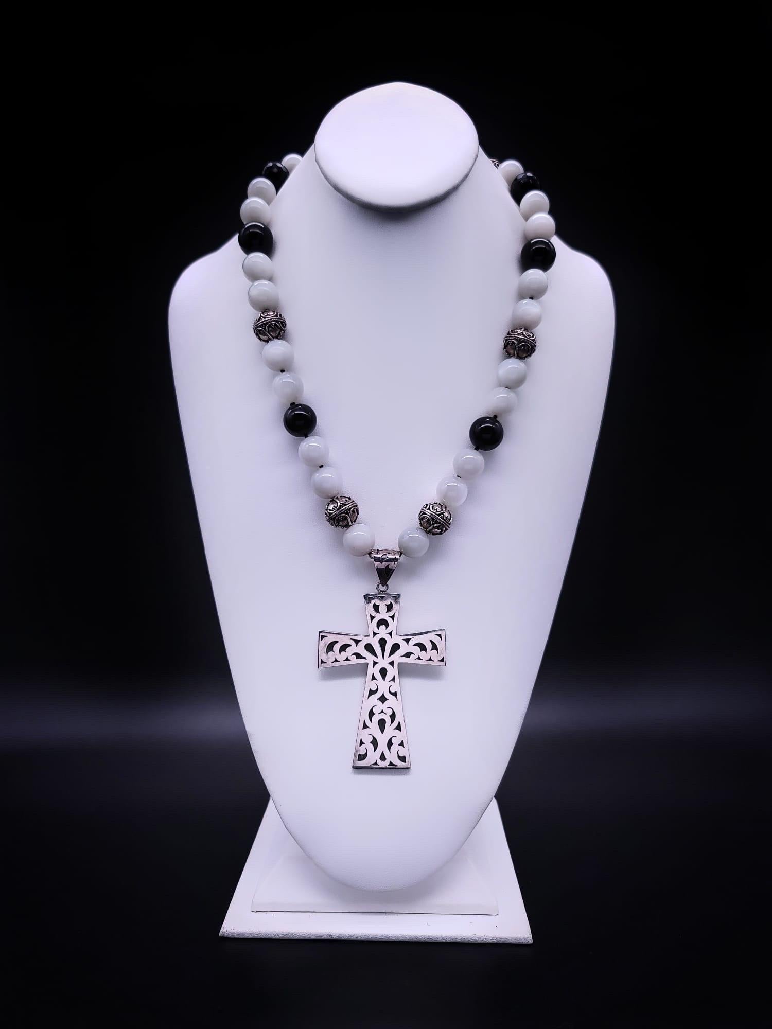 One-of-a-Kind

Heavy signed Sterling Silver cross 7”x 6” manufactured in Bali is suspended from a necklace of white Moonstone, Onyx beads, and filigreed Tibetan Sterling Silver beads. The clasp is of faceted Onyx and Sterling Silver. A very simple