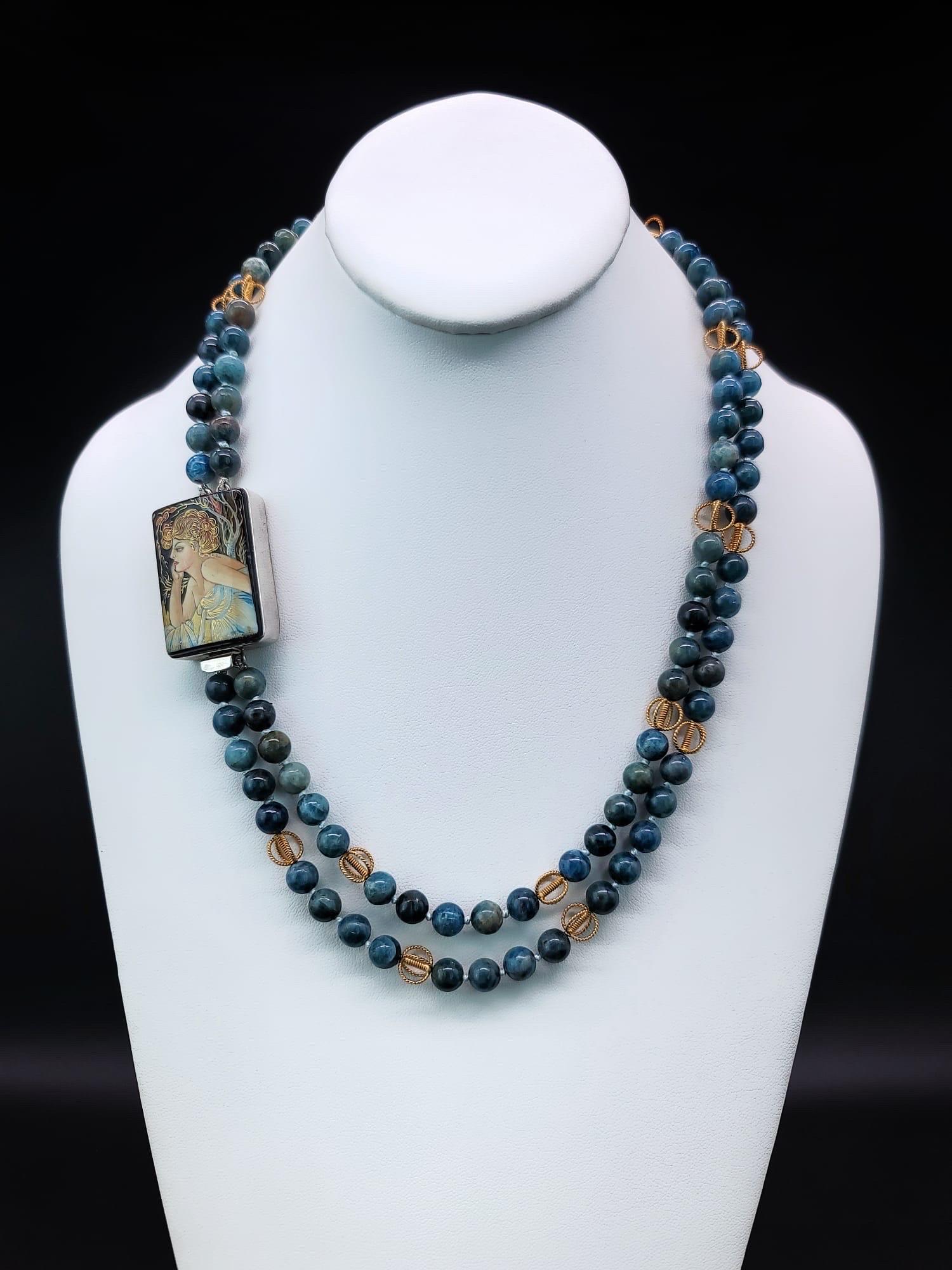 One-of-a-Kind
A double strand of 8mm Apatite beads punctuates by delicate filigree beads spaced at intervals.
The beads provide the backdrop for the lovely art Miniature Sterling Silver box clasp meticulously painted in the traditional manner with