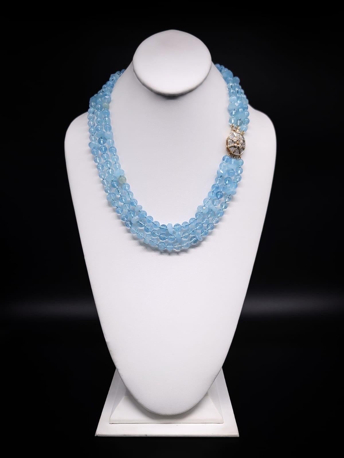 One-of-a-Kind

Romantic Aquamarine  8m.m, 3-strand necklace with a Diamond and 14K gold clasp. The soft blue Aquamarine polished beads are accented with rough-cut aquamarine roundels in the same shade of blue. The irresistible pastel strands are