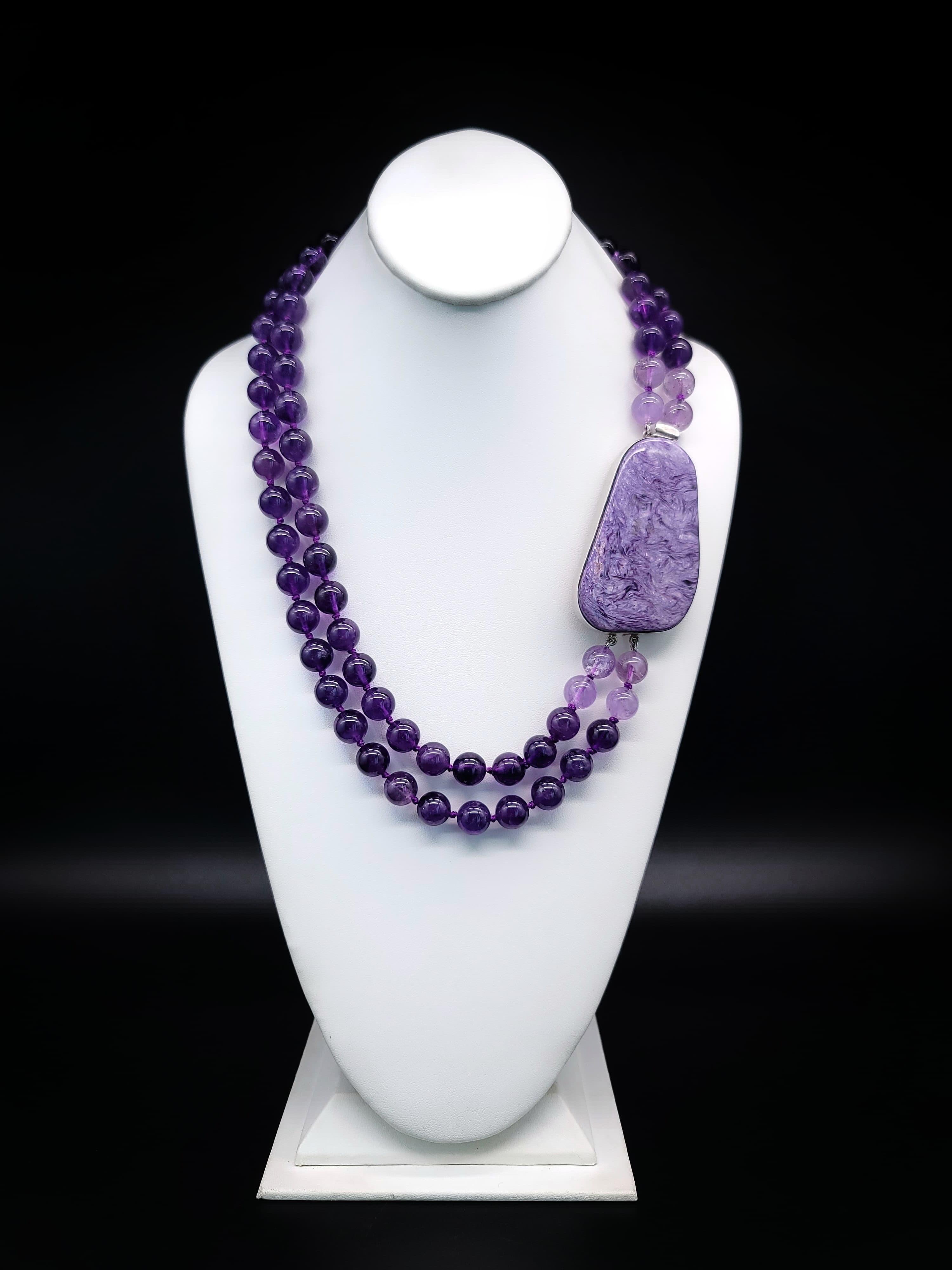One-of-a-Kind
A 2-strand Matinee length necklace of matched deep purple Amethyst.
The centerpiece of this necklace is the large 3”x2 “ Charoite stone meant to be worn as a side clasp. This gemstone is known for its rareness and is only found in one