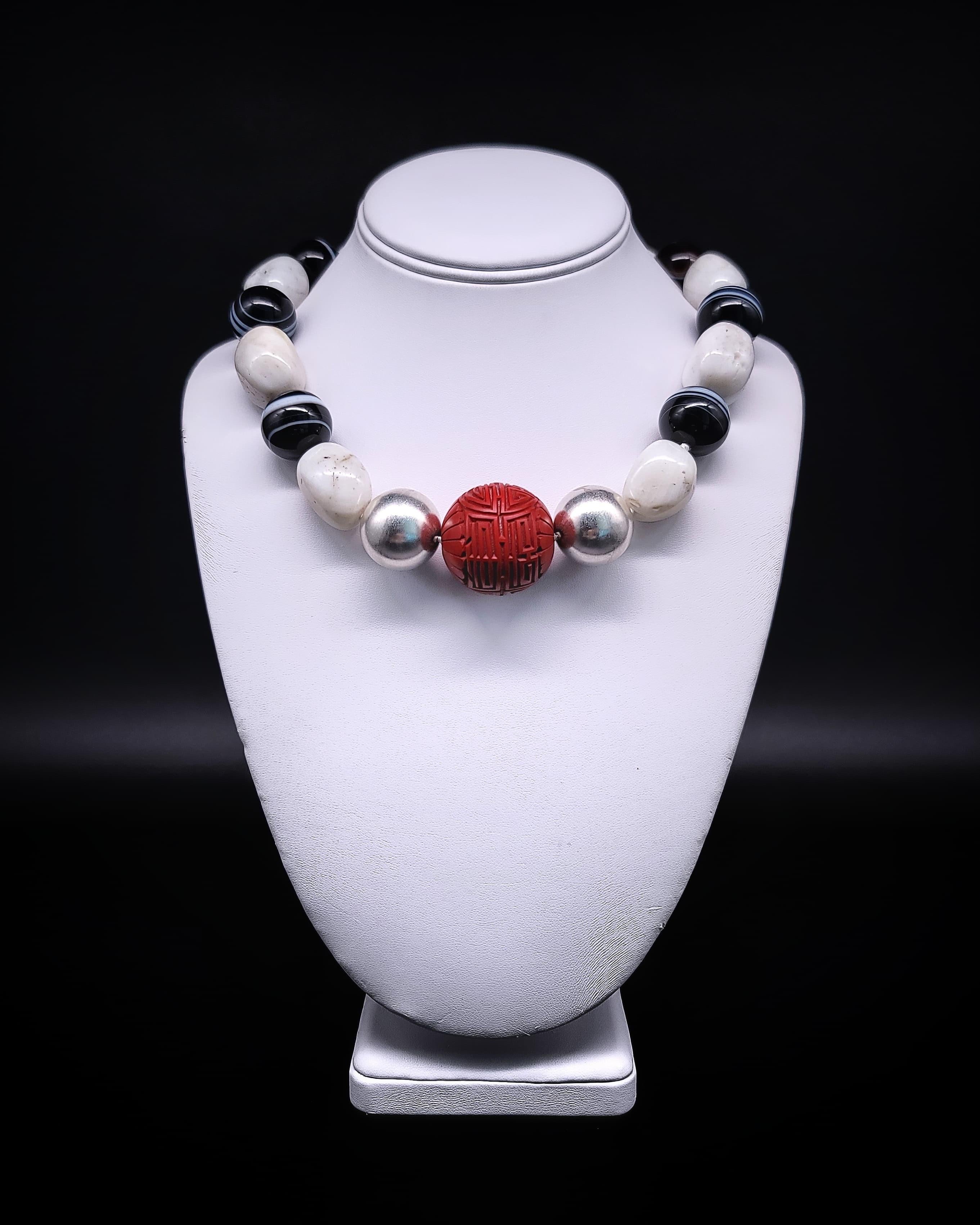 One-of-a-Kind

A strikingly bold necklace of alternating large white oval agate beads with more black than white 18mm polished sardonyx beads creates a mesmerizing pattern. Calling to the center of attention is a pair of 20mm sterling silver balls