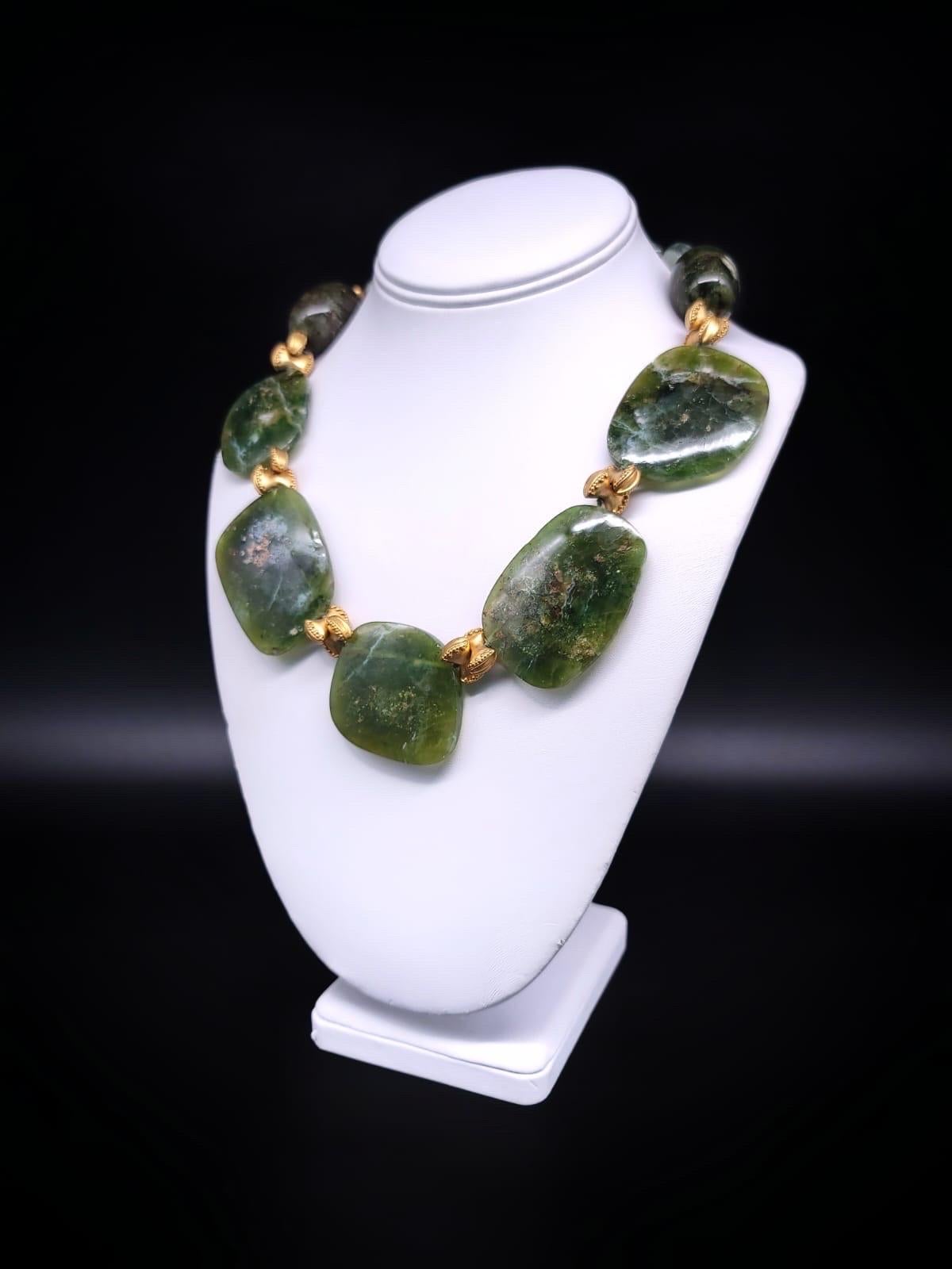 One-of-a-Kind
Indulge in the captivating allure of this unique Green Opal necklace, featuring large polished plates that shimmer and dance in the light, just like the finest Opals do. The stunning green hue of the Opals is perfectly complemented by