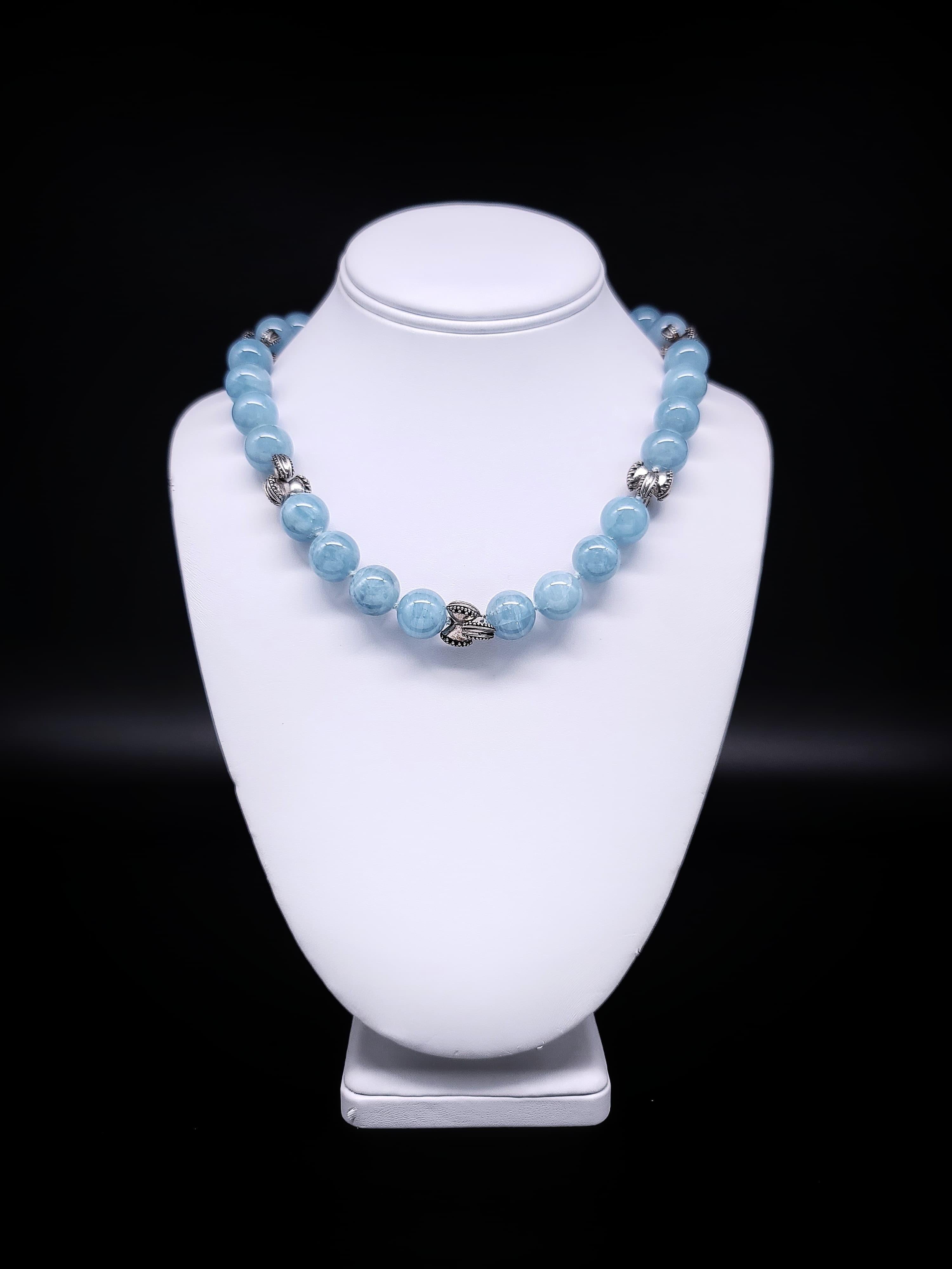 One-of-a-Kind

Perfectly matched 14mm polished Aquamarine beads interspersed with hand-crafted Sterling Silver love knots. The clasp is a  gleaming abalone disc set into silver.
Silk hand-knotted
Approx: 18 inch
